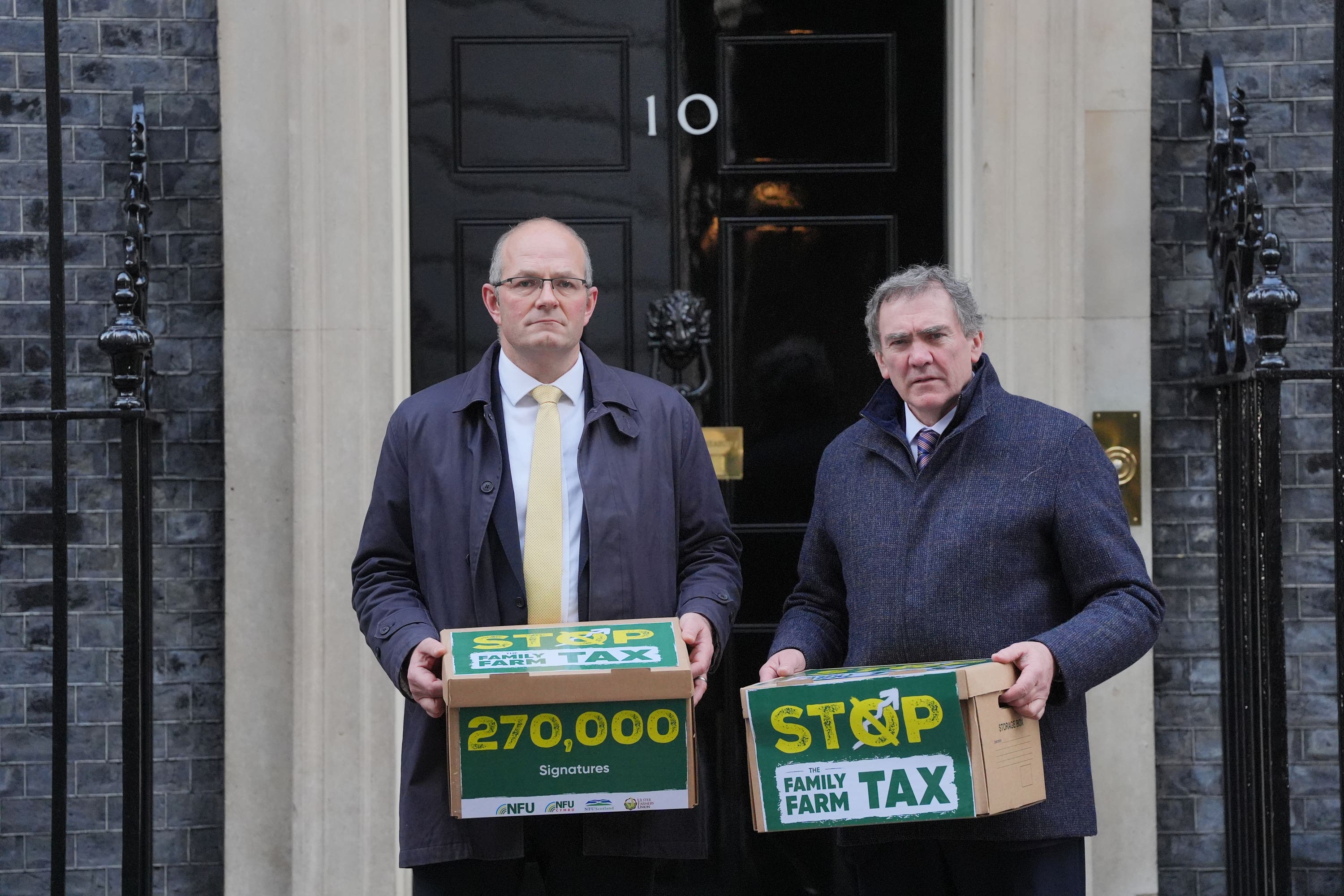 National Farmers’ Union president Tom Bradshaw, left, and NFU Cymru president Aled Jones handing in a petition at No 10