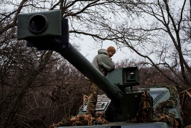 <p>A Ukrainian serviceman of Azov brigade stands atop of a self-propelled howitzer Dita after firing towards Russian positions at frontline in Donetsk region</p>