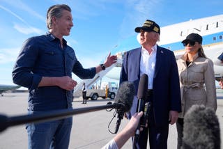 President Donald Trump and first lady Melania Trump listen to California Gov. Gavin Newsom after arriving on Air Force One at Los Angeles International Airport in Los Angeles, Friday, Jan. 24, 2025