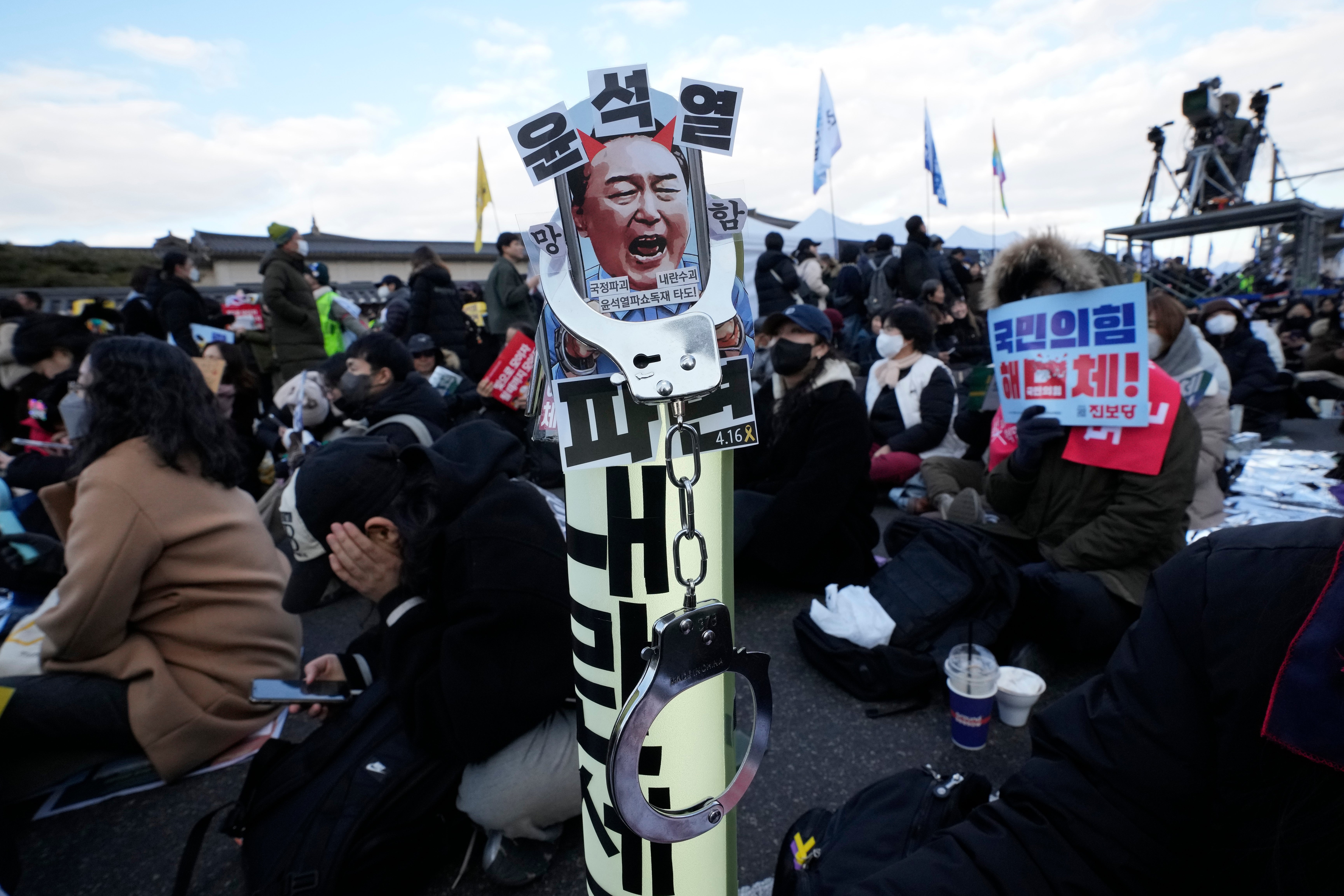 An image of impeached South Korean president Yoon Suk Yeol is displayed during a rally in London demanding his immediate indictment