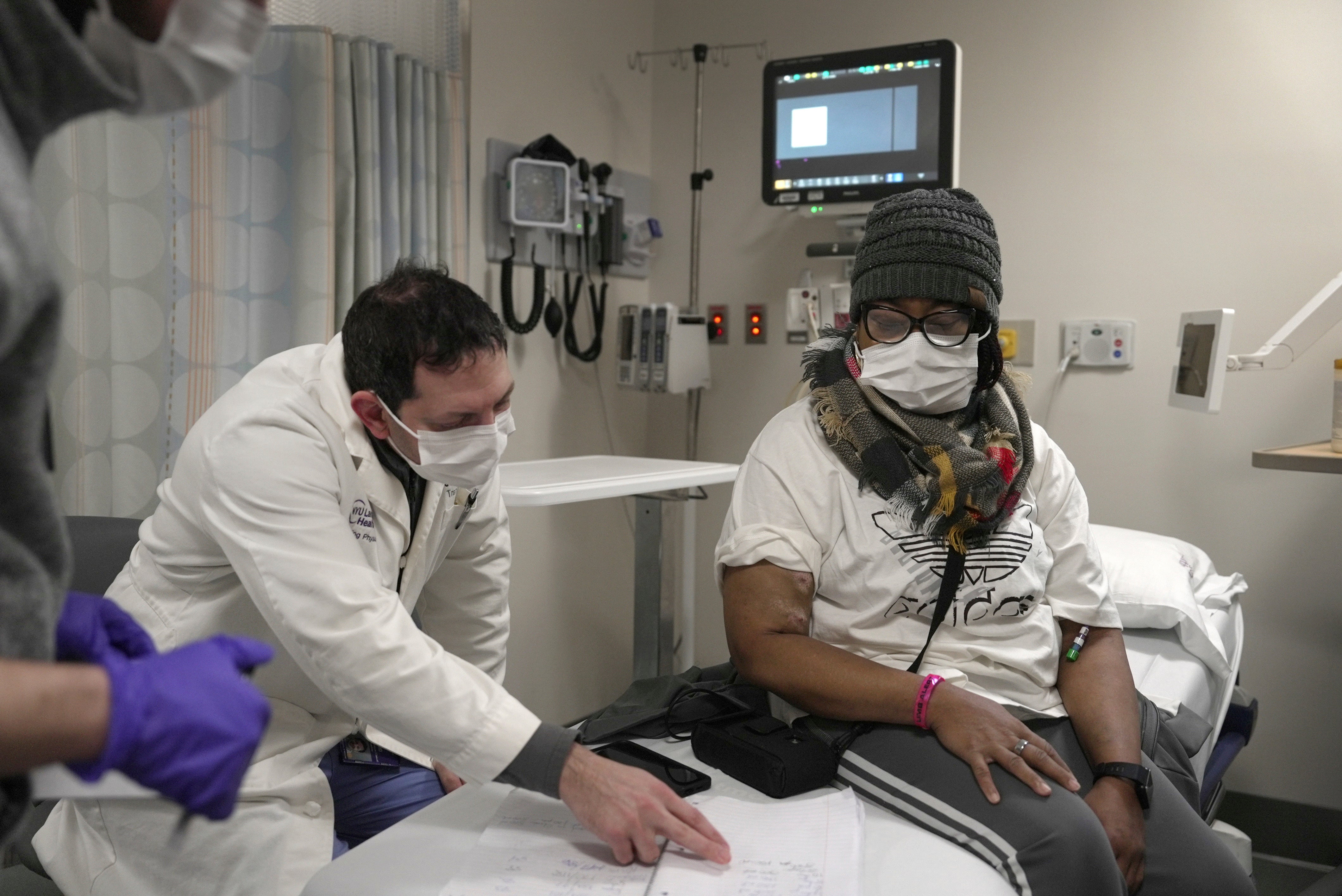 Towana Looney, who received a pig kidney transplant in November 2024, goes over notes about her recovery with Dr. Jeffrey Stern at NYU Langone Health in New York. She has lived for 61 days with the pig organ inside her