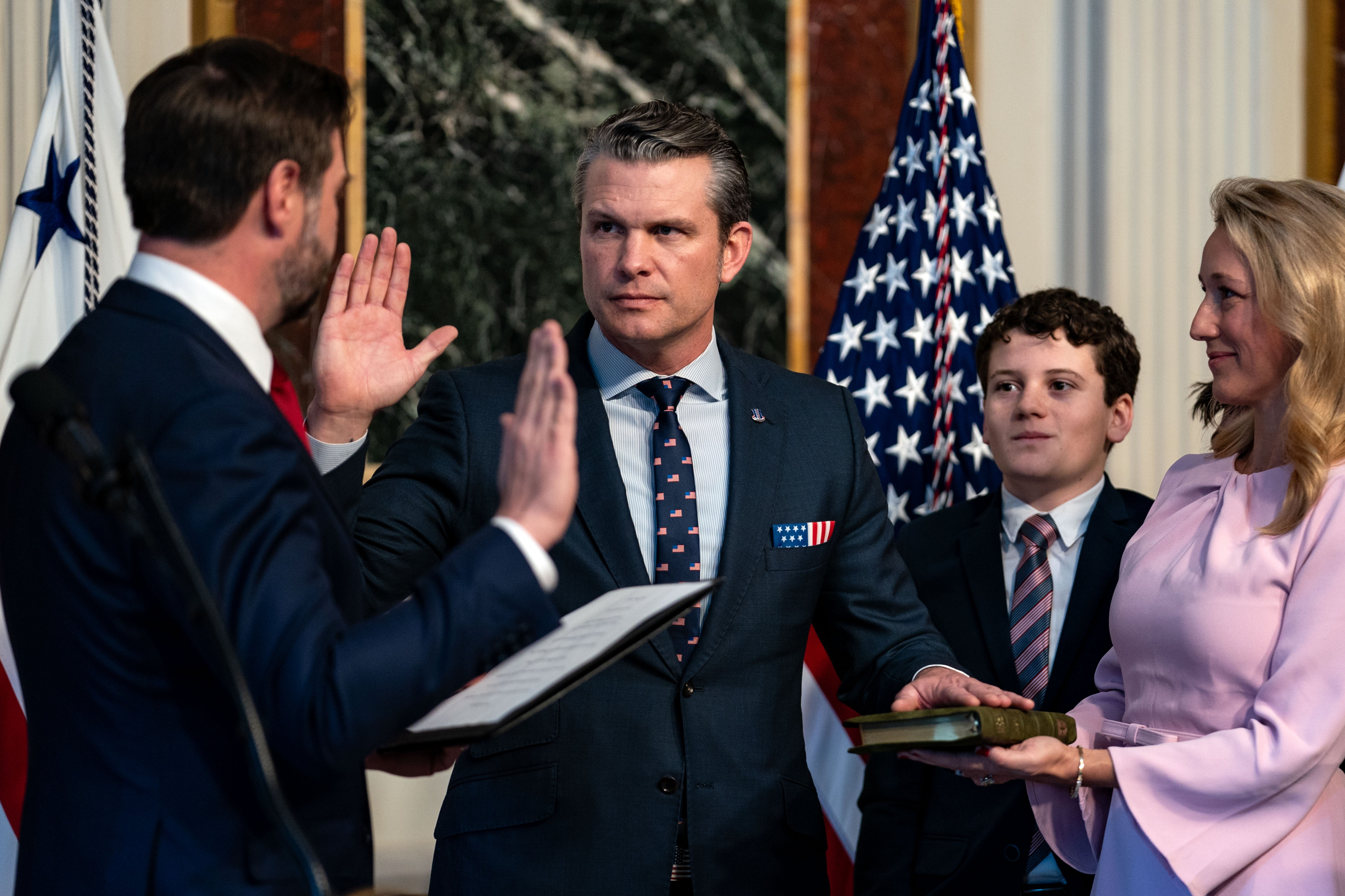 Vice President J.D. Vance (L) swears in Secretary of Defense Pete Hegseth alongside his wife Jennifer Rauchet in the Indian Treaty Room in the Eisenhower Executive Office Building on January 25