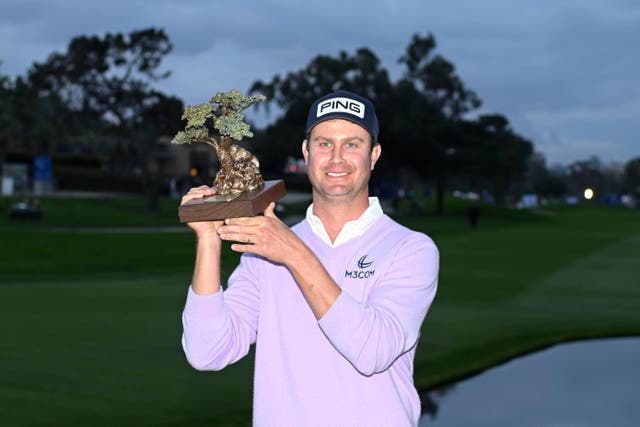 Harris English holds up the trophy after winning the Farmers Insurance Open (AP Photo/Denis Poroy)