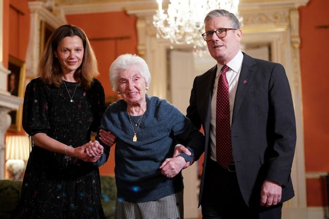 Prime Minister Sir Keir Starmer and his wife Lady Victoria help Holocaust survivor Renee Salt during a reception to mark Holocaust Memorial Day at 10 Downing Street (Alberto Pizzoli/PA)