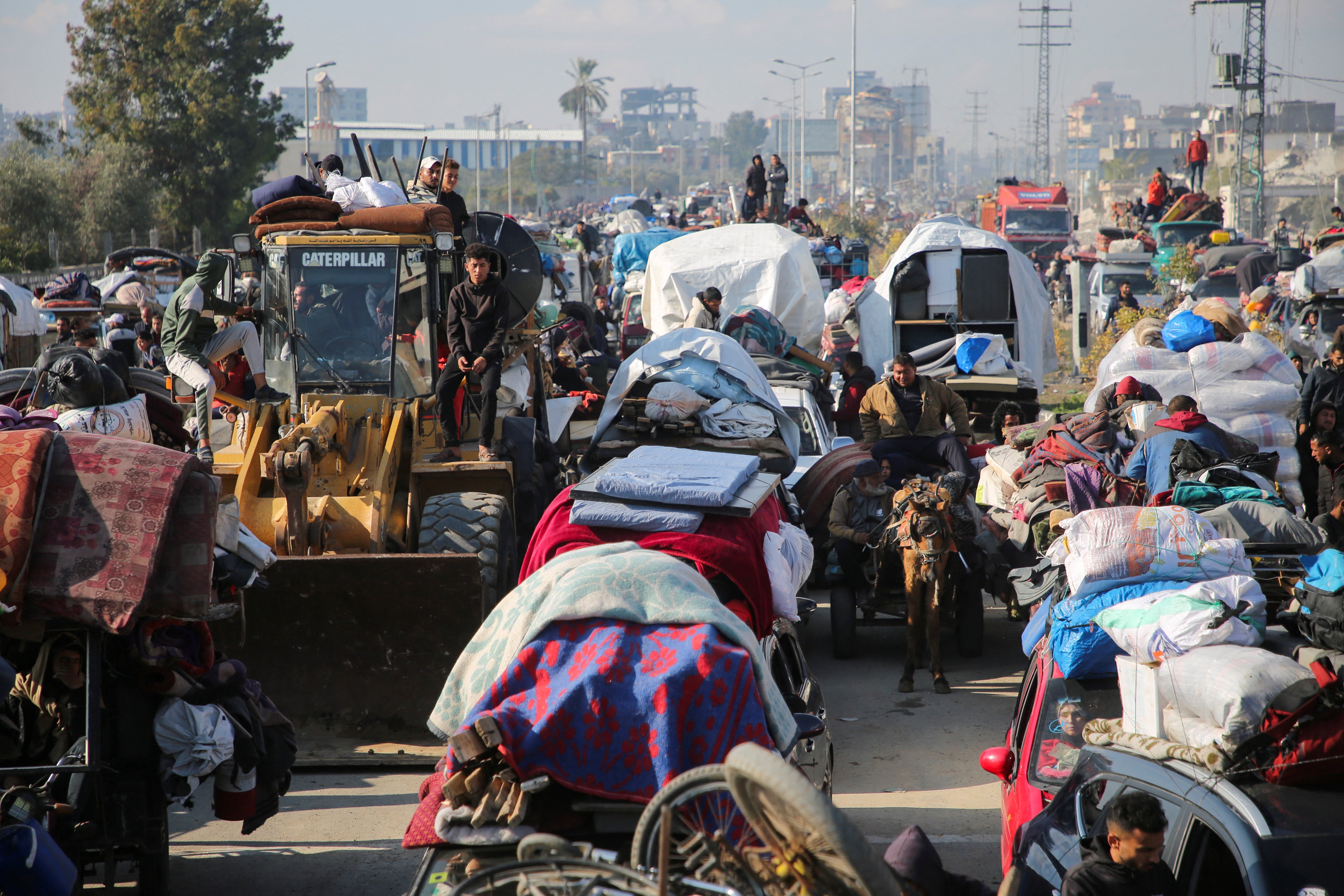 Palestinians gather as they wait to be allowed to move into northern Gaza