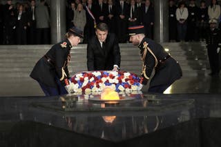 French President Emmanuel Macron lays a wreath of flowers at the Paris Holocaust Memorial