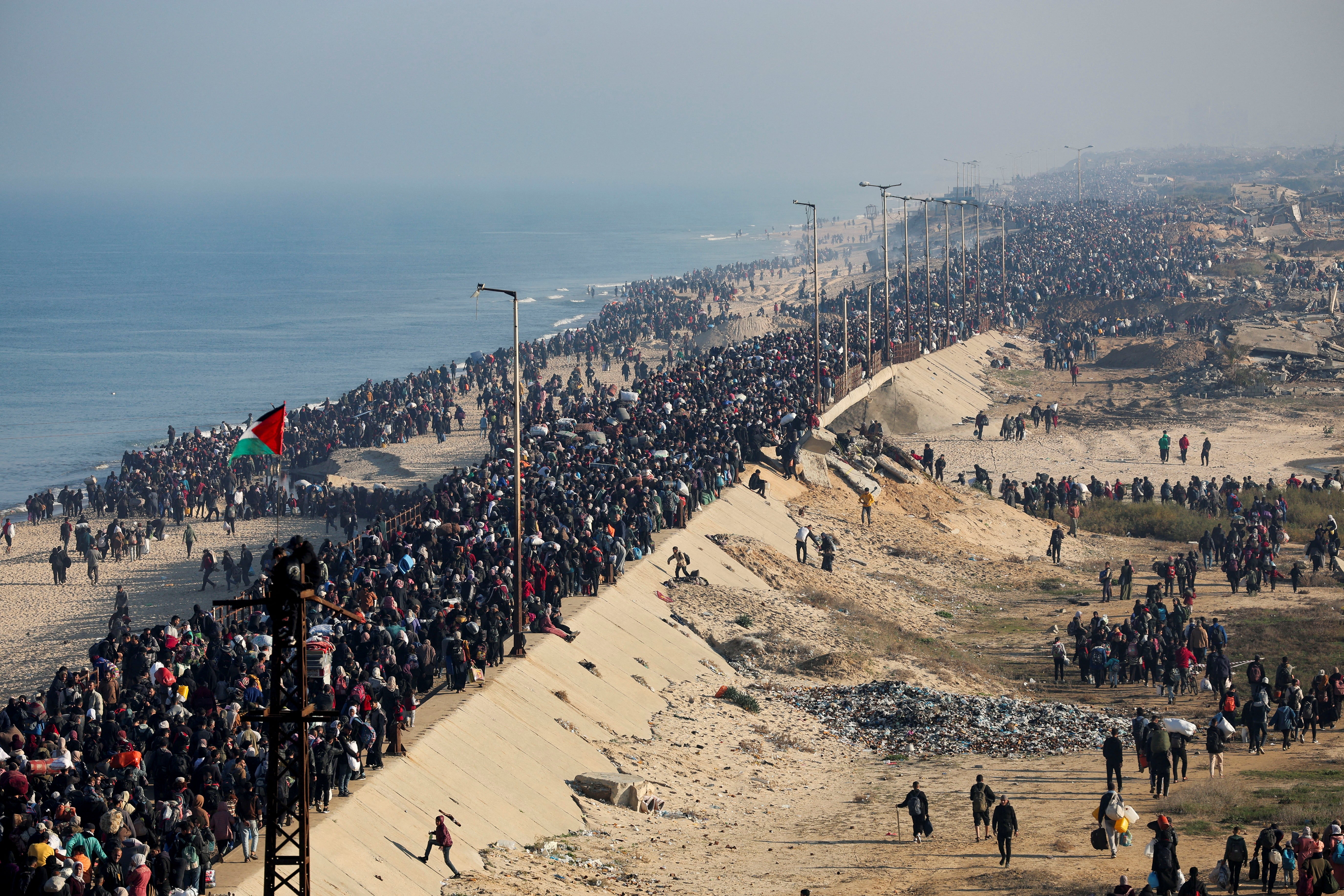 Displaced Palestinians make their way back to their homes in northern Gaza on Monday