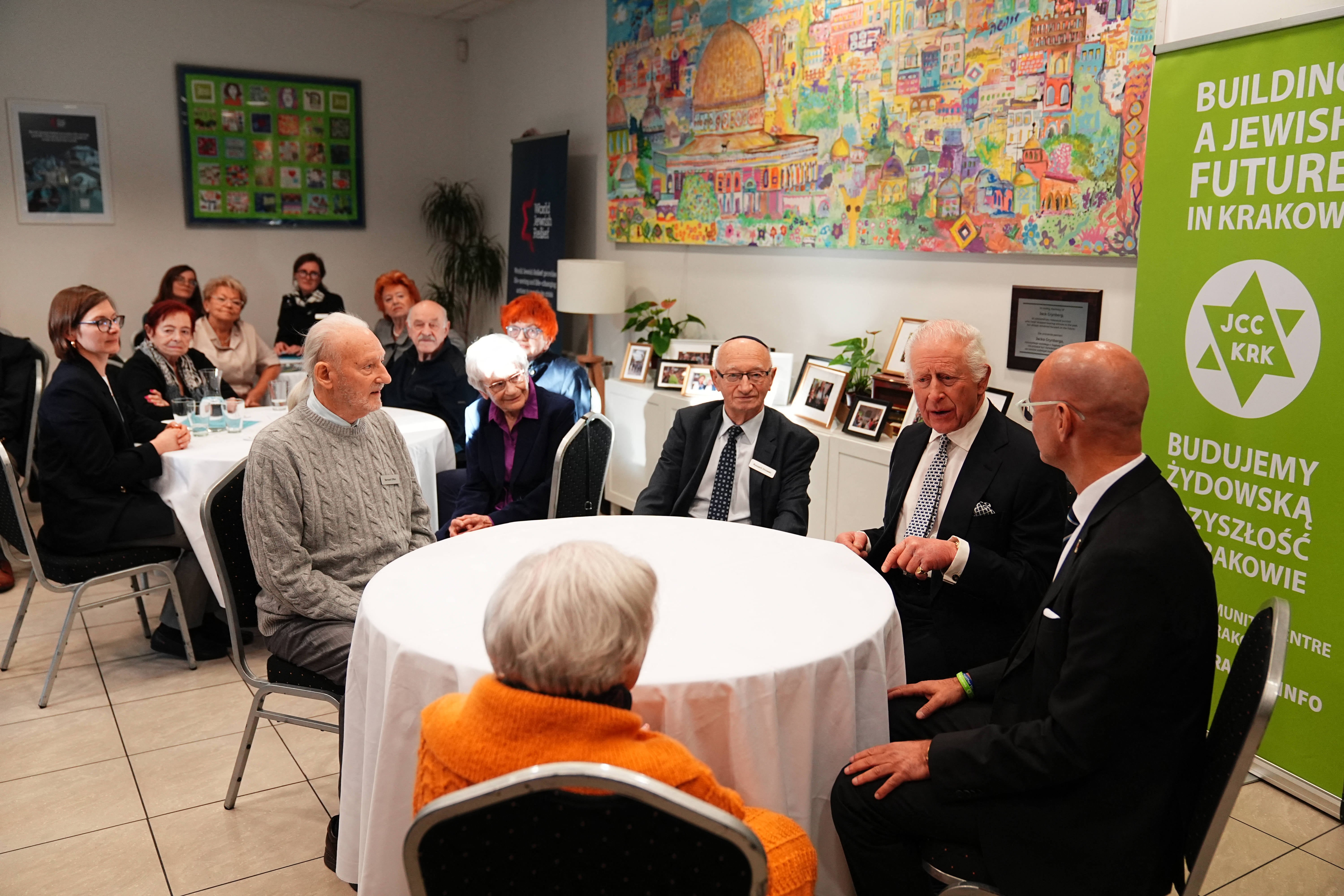 King Charles speaks with Holocaust survivors as he visits the Jewish Community Centre (JCC) in Krakow, Poland, on Monday