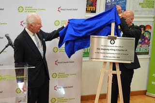 King Carlos III presents a plaque during his visit to the Jewish Community Center (JCC) Krakow,