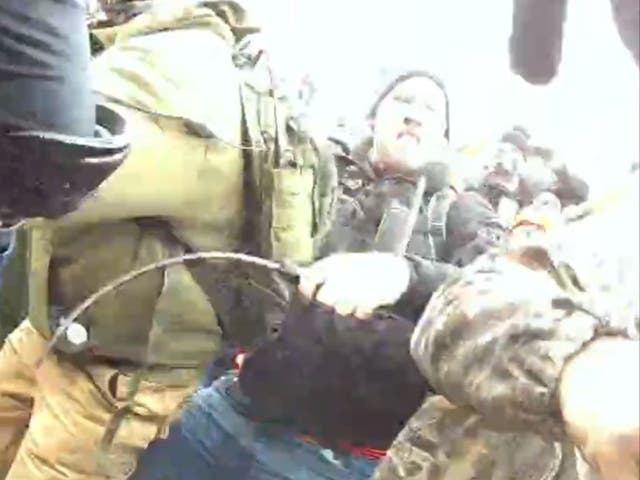 <p>An image from court documents of Andrew Taake attacking a police officer with a whip</p>