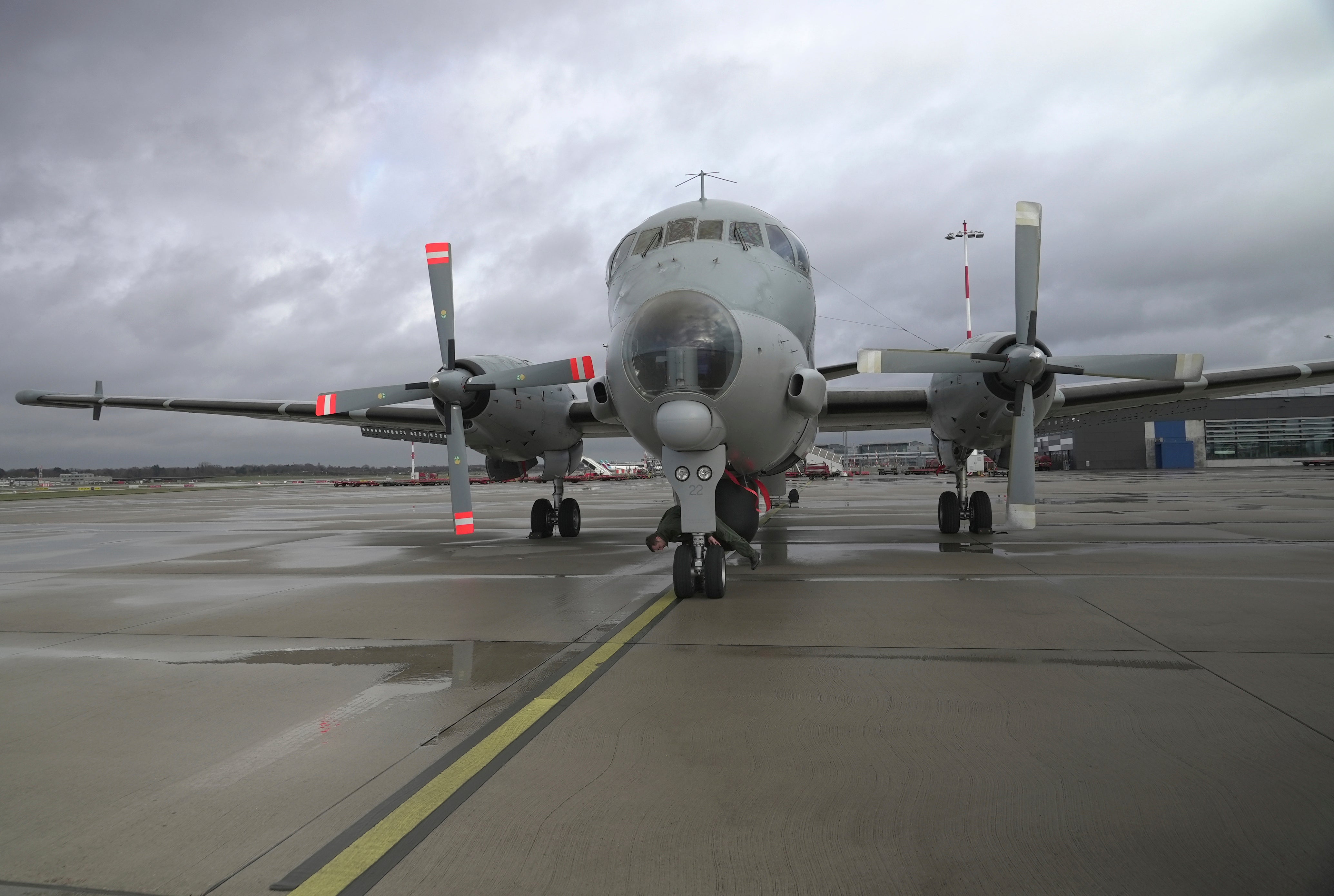 Pilot Lt. Terry (surname withheld by the French military) inspects the wheels of a French Navy Atlantique 2 surveillance plane before its takeoff from Hamburg, Germany