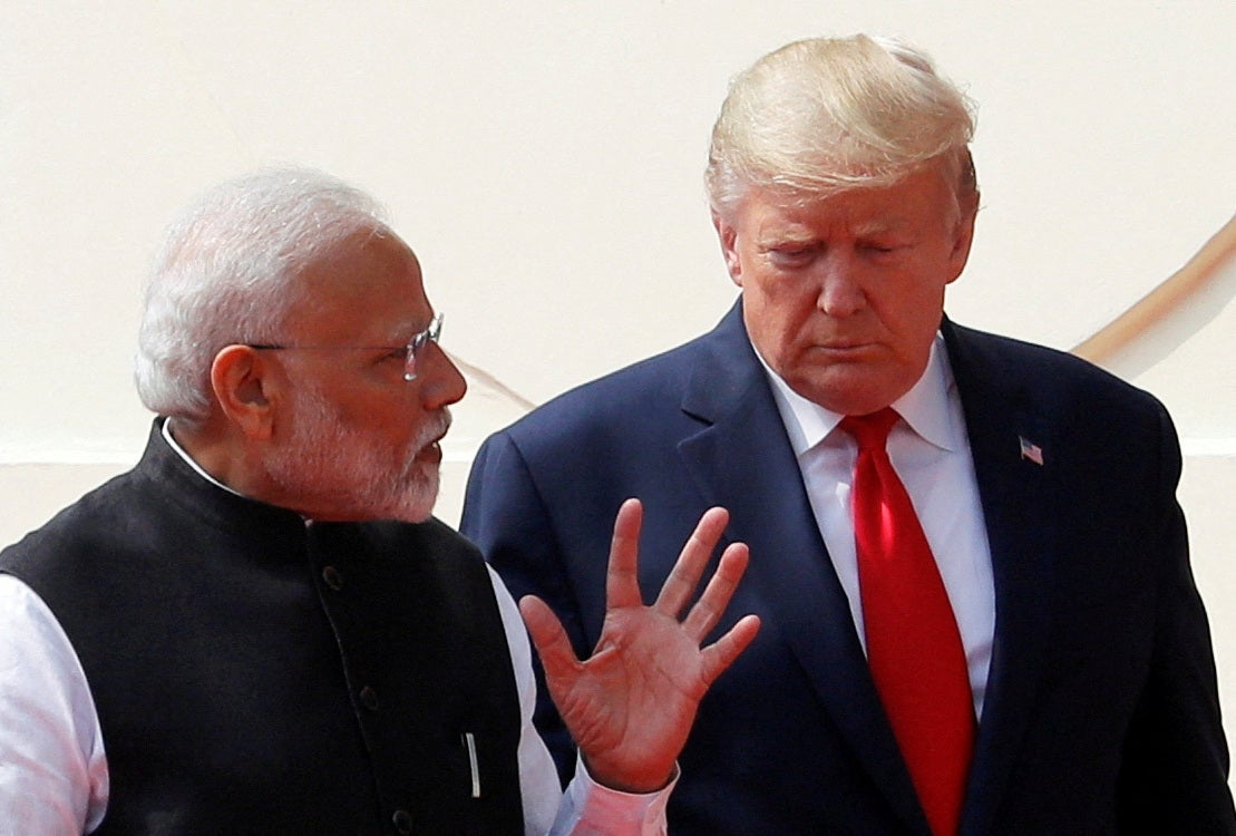 Donald Trump and Narendra Modi talk as they arrive for a joint news conference