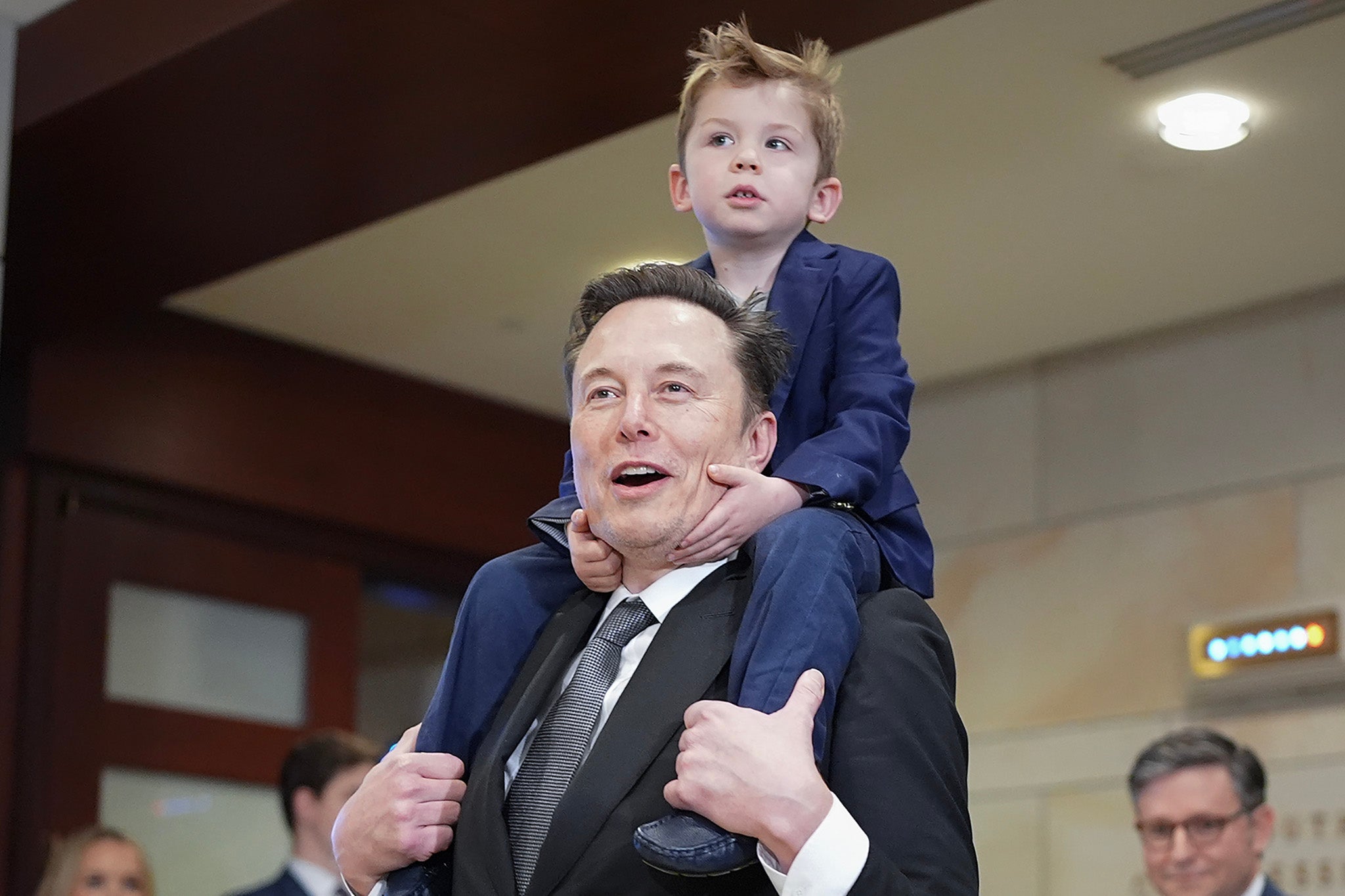 Elon Musk carries his son ‘X’ on his shoulders at the Capitol in December before meeting with members of Congress