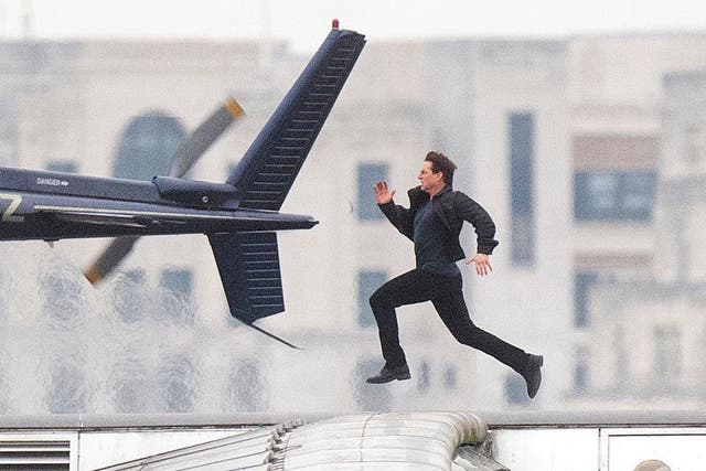 Tom Cruise runs along Blackfriars Bridge in London, during filming for Mission Impossible 6 (Victoria Jones/PA)