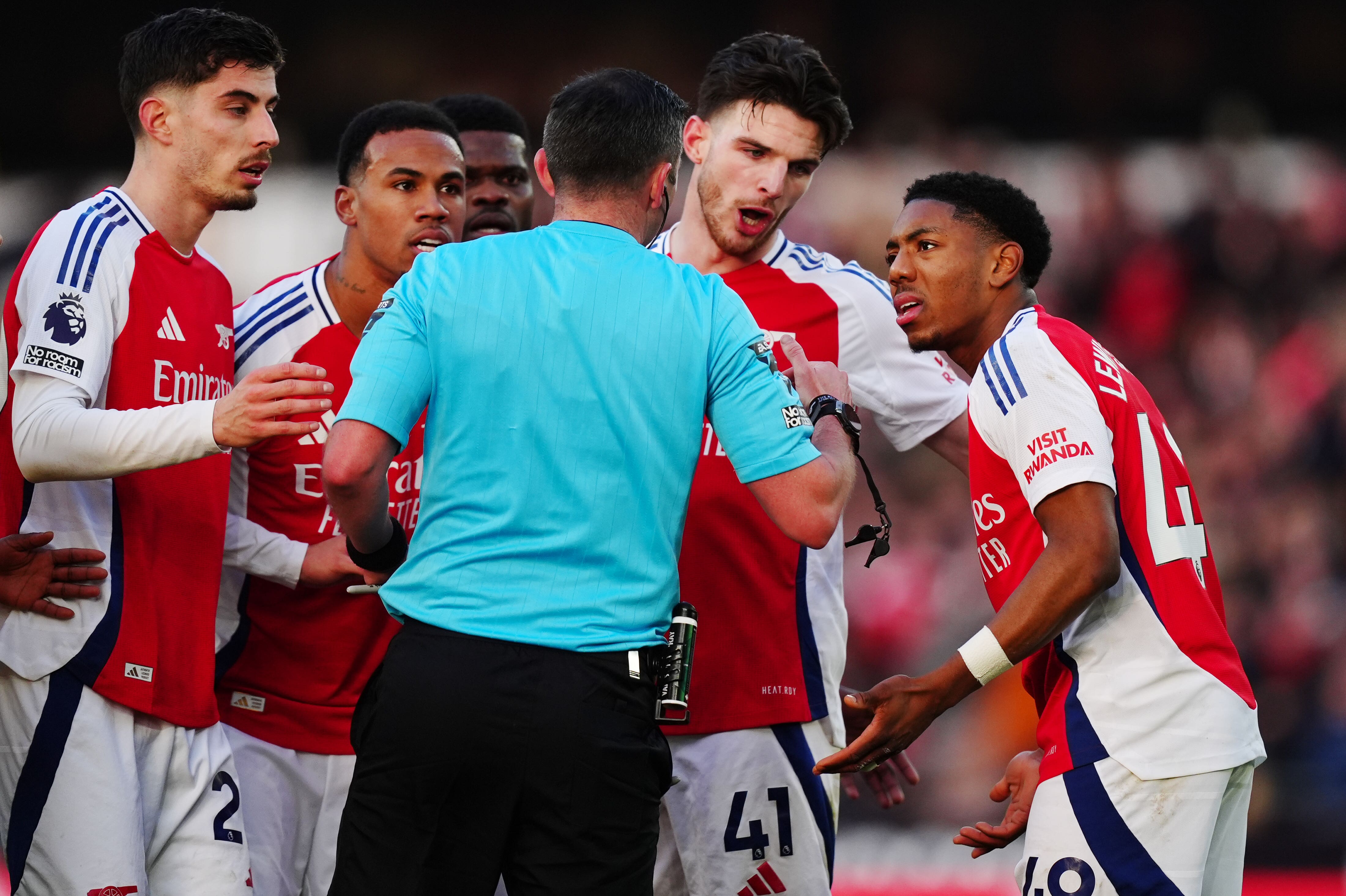 Myles Lewis-Skelly, right, was shown a red card by referee Michael Oliver against Wolves