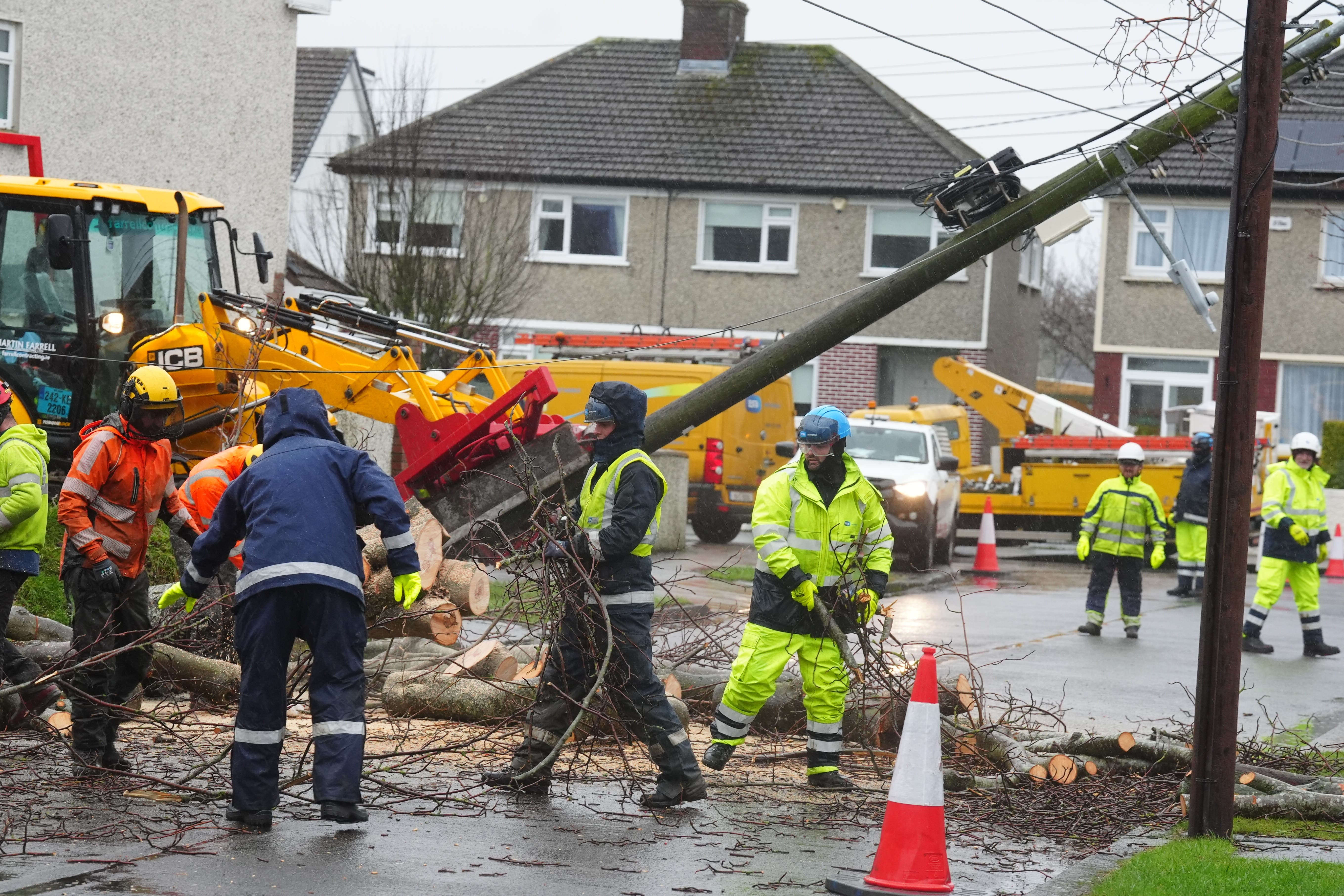 Workers clearing a fallen tree on Grove Park Drive in Dublin (Brian Lawless/PA)