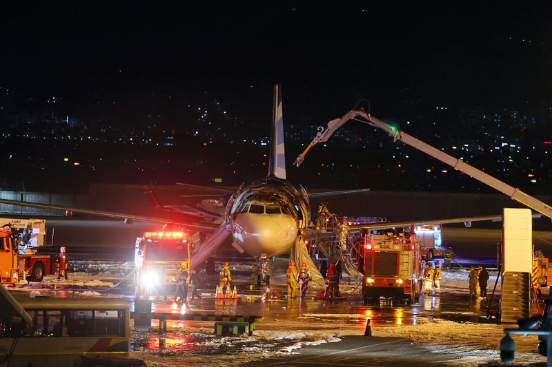 Passengers and crew evacuated as plane catches fire on South Korean runway