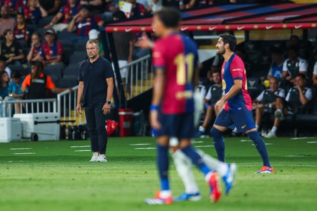 <p>Barcelona manager Hansi Flick watches over his team from the touchline</p>