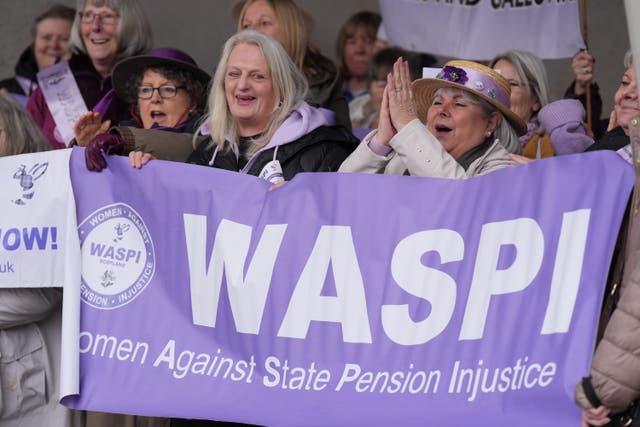 People at a Women Against State Pension Inequality protest outside the Scottish Parliament in Edinburgh, campaigning for justice and full compensation (Andrew Milligan/PA)