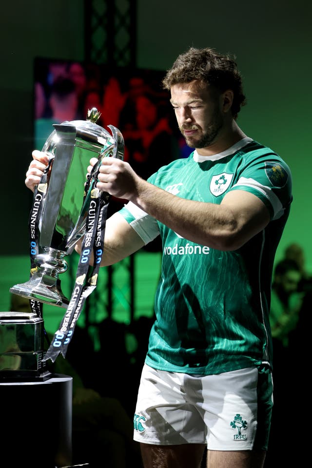 <p>Captain Caelan Doris of Ireland holds the trophy at the Guinness Six Nations 2025 launch at Spazio Field</p>