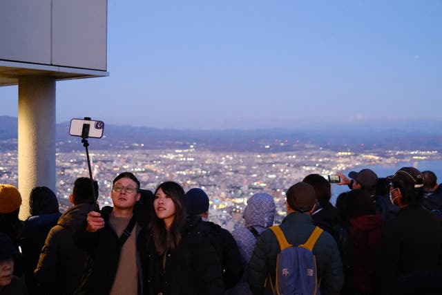 <p>File. Tourists visit Mount Hakodate in the Hokkaido prefecture of Japan</p>