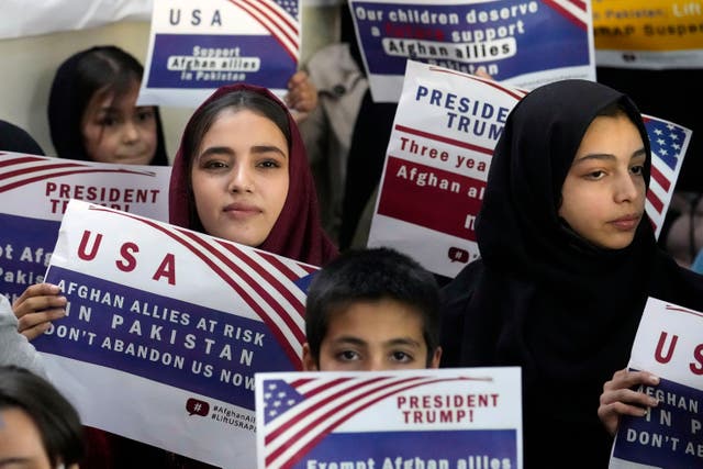 <p>Afghan refugees hold placards during a meeting to discuss their situation after President Donald Trump paused U.S. refugee programs, in Islamabad, Pakistan on  January 24, 2025</p>