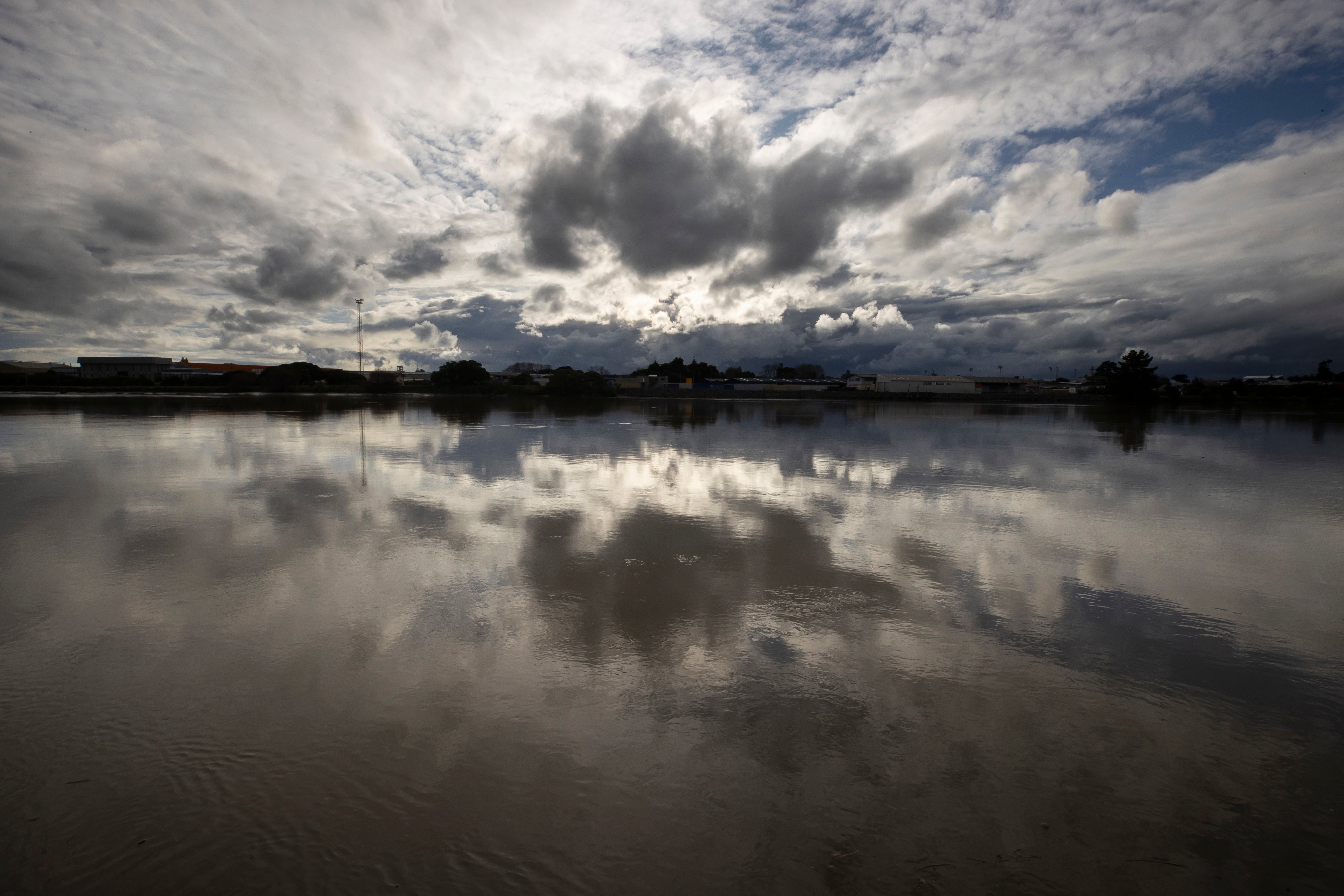 Clouds are reflected in the Whanganui River at the town of Whanganui, New Zealand,