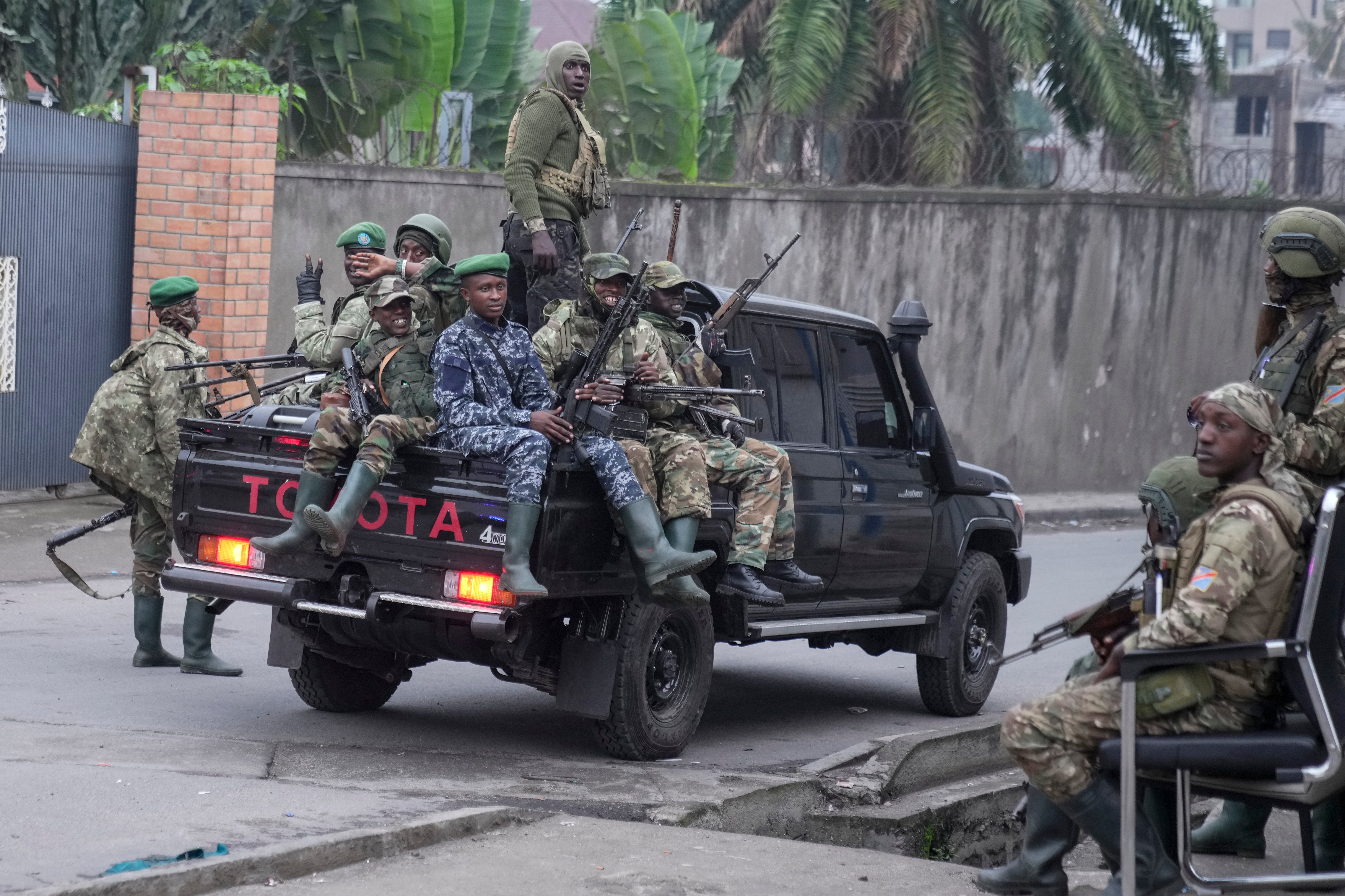 M23 rebels drive through the streets of Goma after taking up arms against the Congolese government