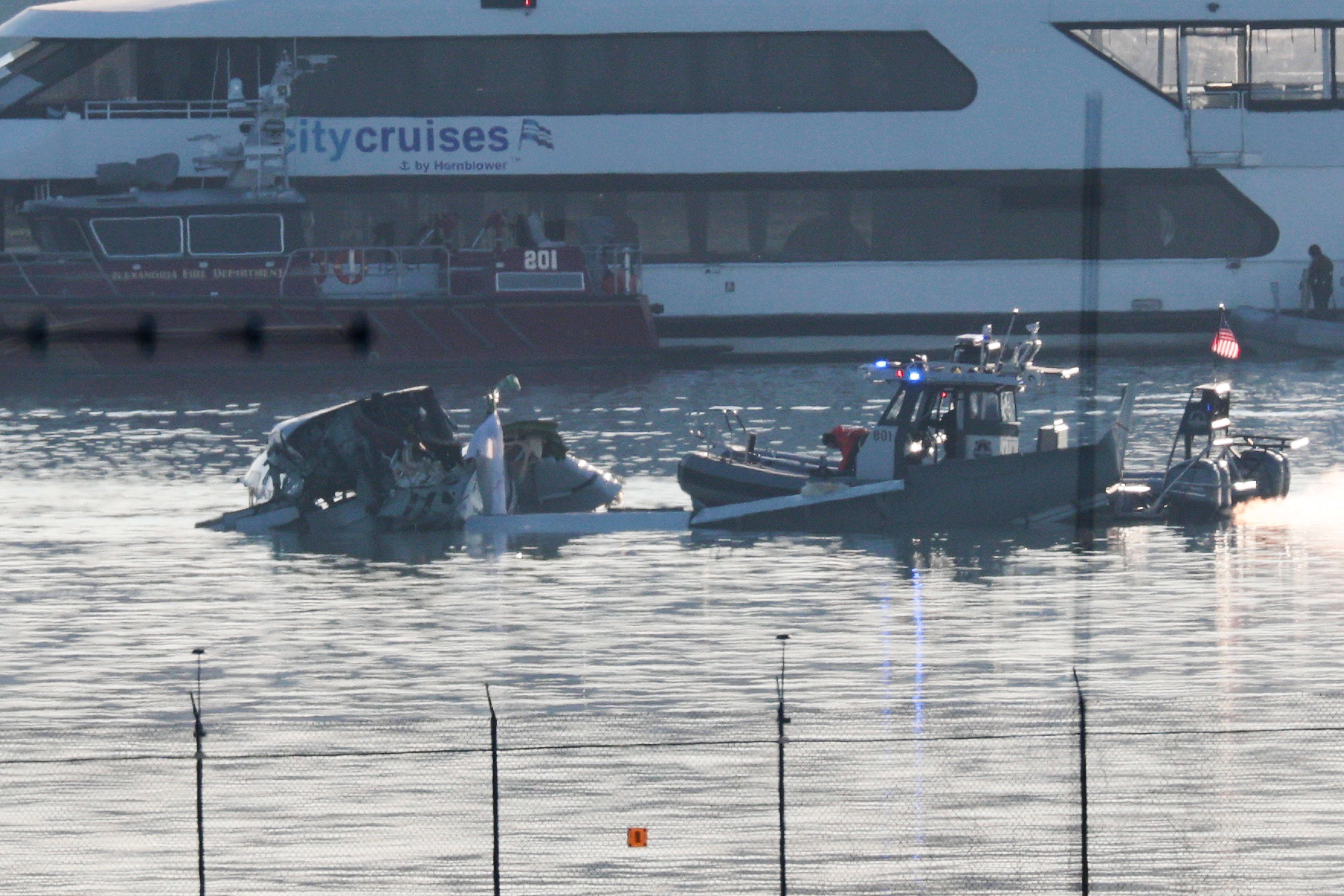 Emergency crews search the Potomac River after an American Airlines jet and Army helicopter collided and crashed into the water