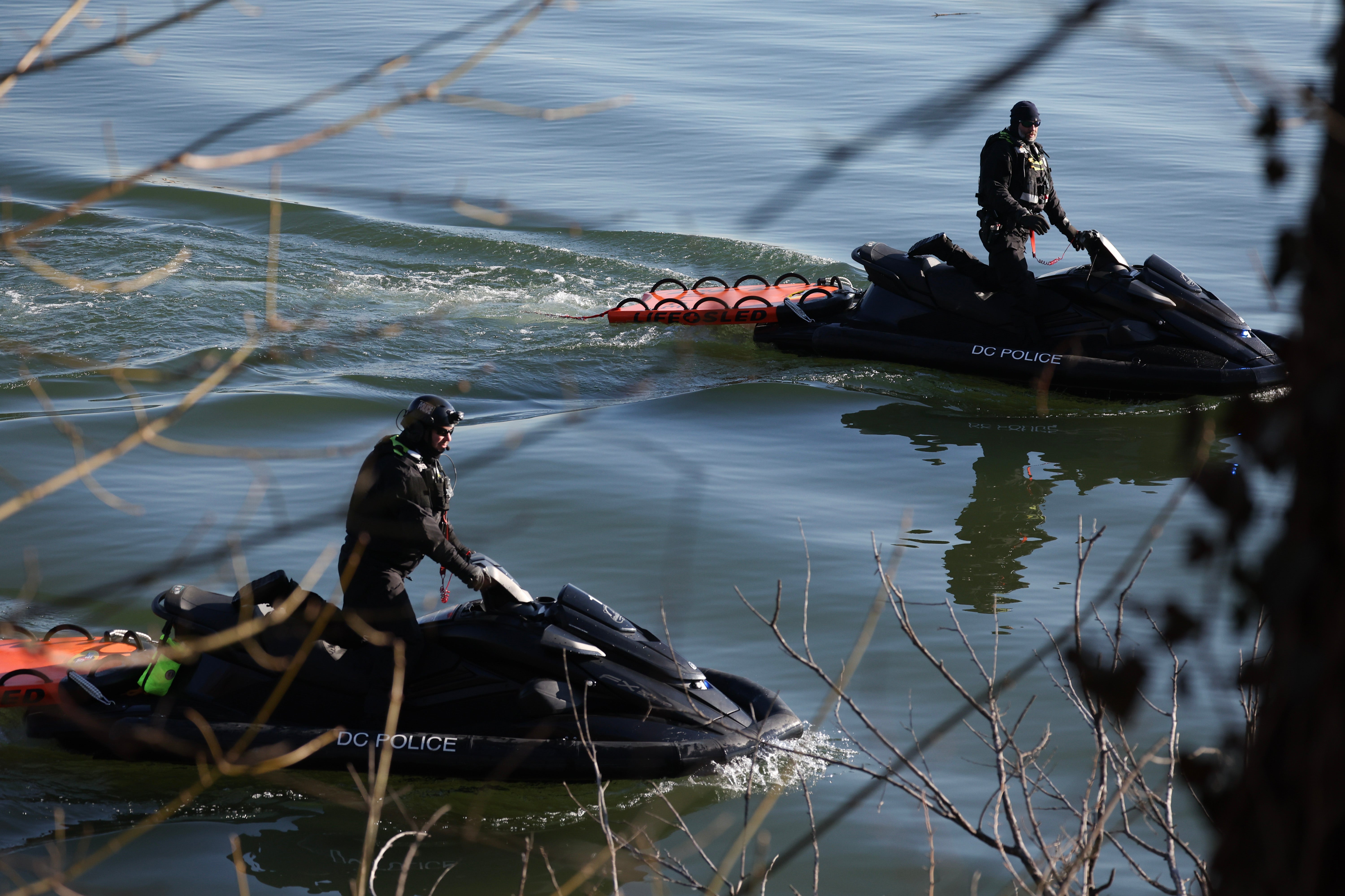 Washington, DC police help investigate near the crash site of the American Airlines plane on the Potomac River on Thursday