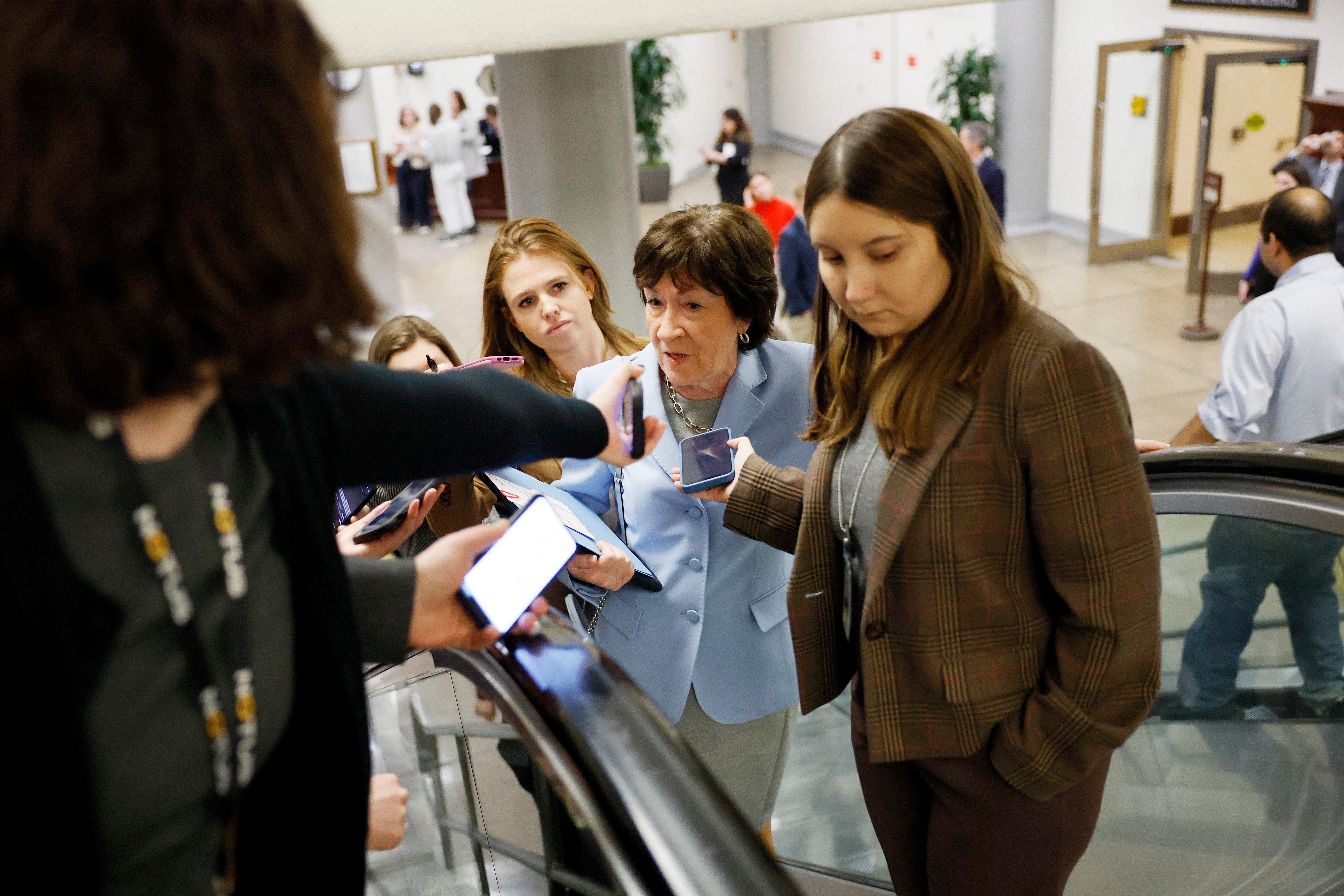 Sen. Susan Collins of Maine, center, grilled Gabbard about her previous praise of Edward Snowden.