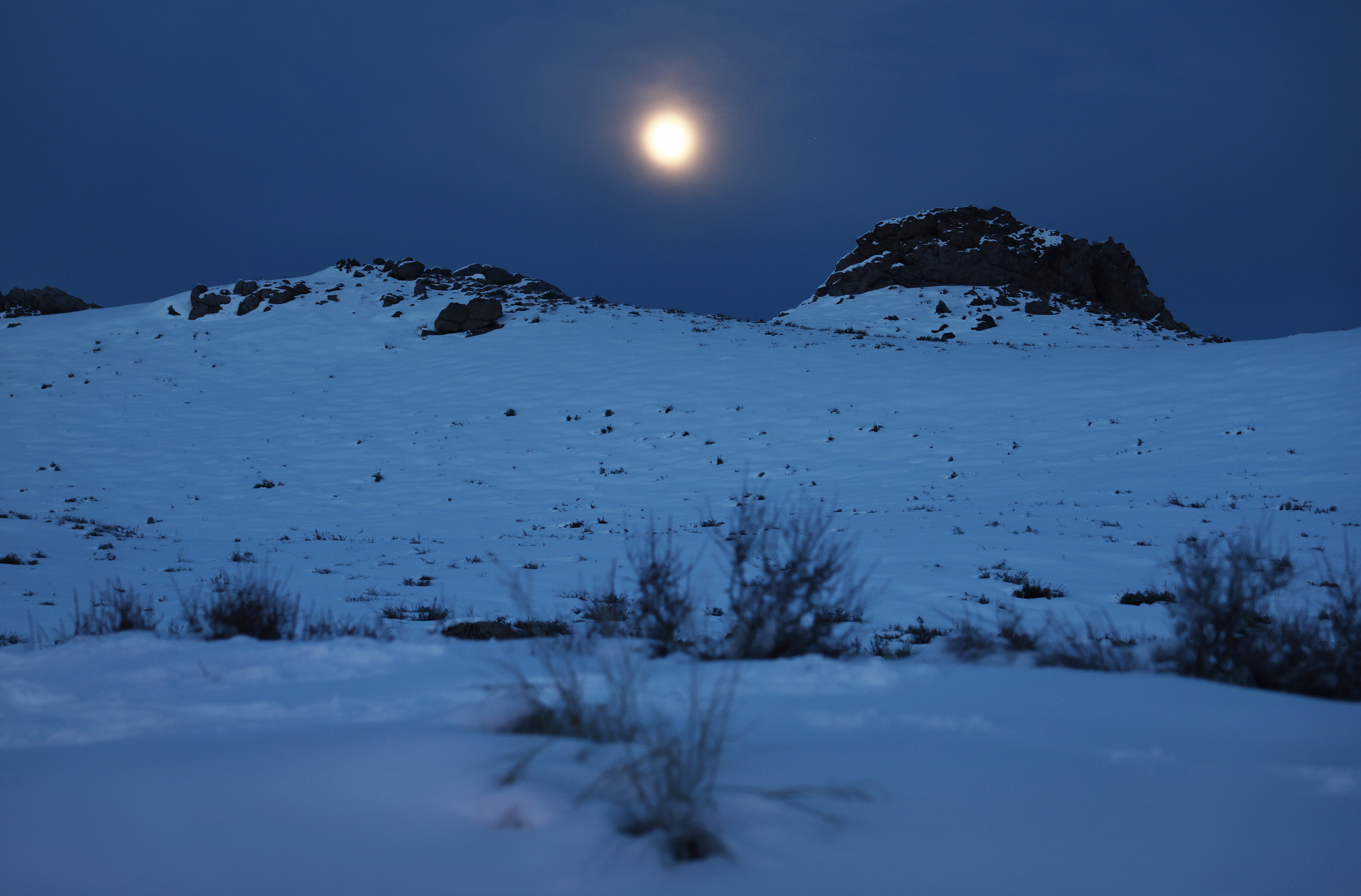 The moon rises over a snow covered hill after recent storms in February of last year near Mammoth Lakes, California. The snow moon is also known as the storm moon