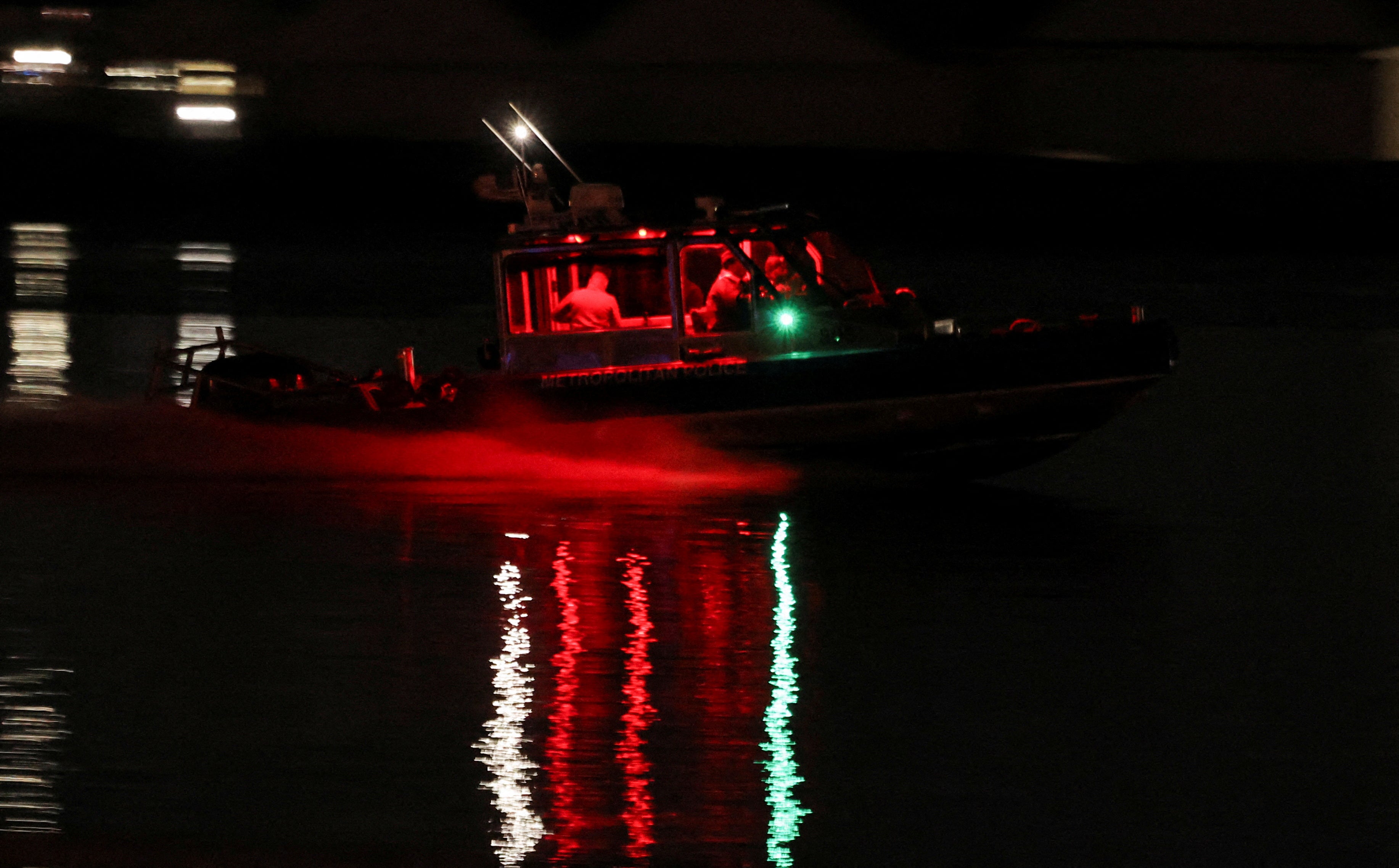 A search and rescue boat searches for the water in the Potomac River near the site of the crash after American Airlines Flight 5342 collided with a helicopter as he approached Ronald Reagan Washington National Airport