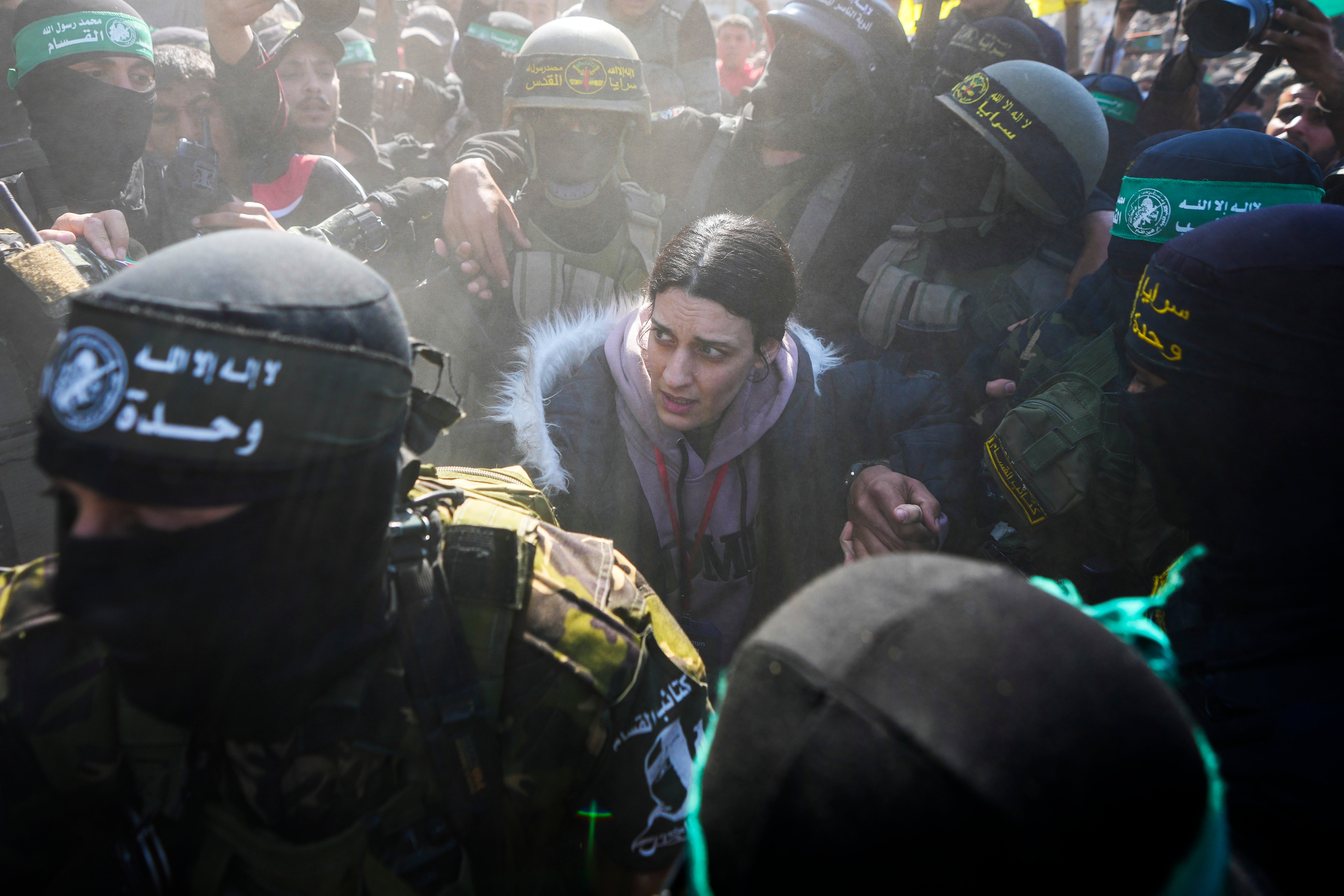 Israeli Arbel Yehoud, 29, is escorted by Hamas and Islamic Jihad fighters as she is handed over to the Red Cross in Khan Younis, southern Gaza Strip