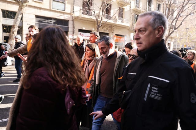 <p>Teacher Josep Torrent (C), 49, reacts after being informed that his eviction will be carried out next early Tuesday morning, as he walks surrounded by residents and a tenants' union to prevent the eviction of a building called Casa Orsola, which has become a symbol of Barcelona's housing crisis, in Barcelona, Spain January 31, 2025</p>