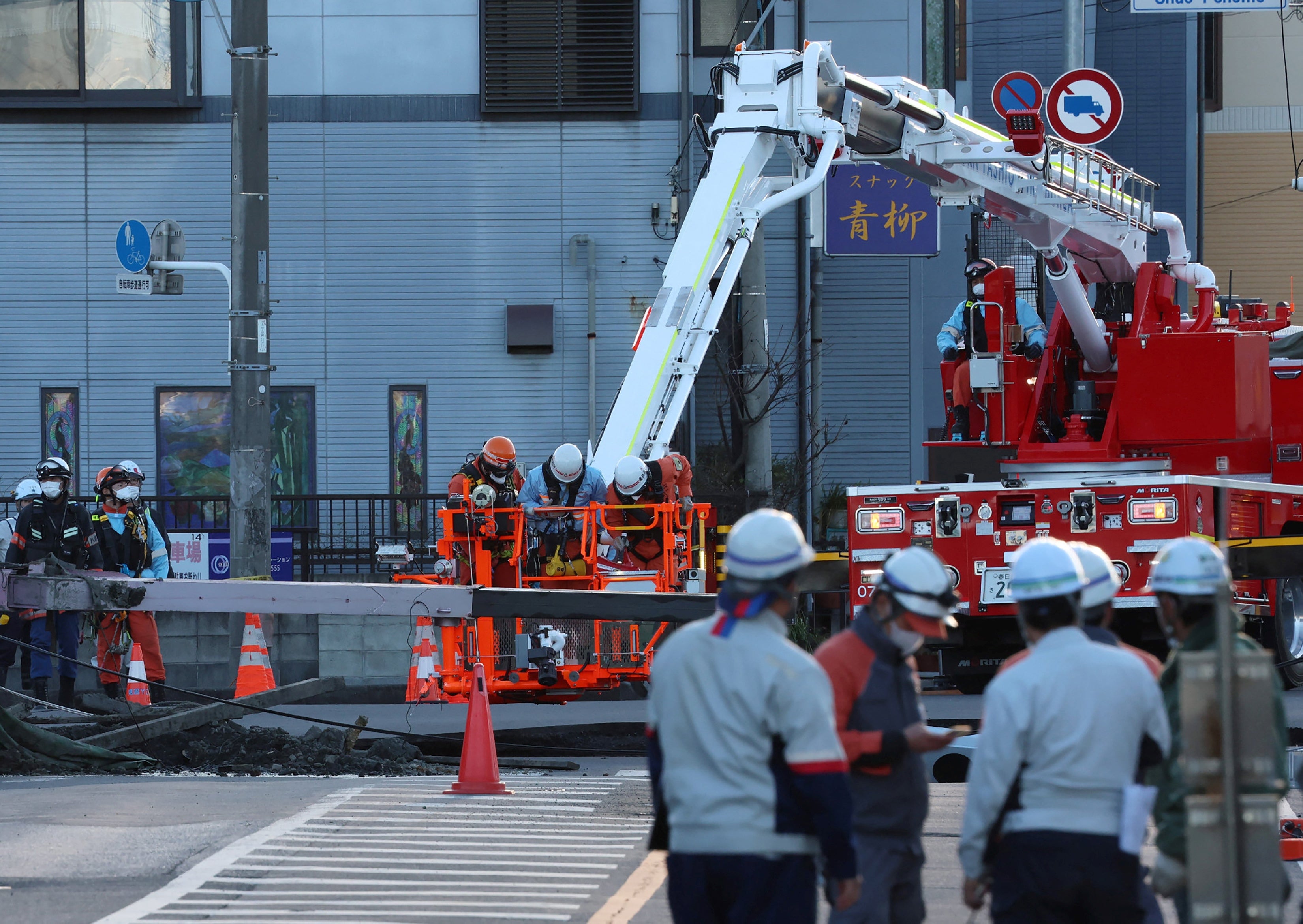 Rescue enactment    continues to prevention  a motortruck  operator  whose conveyance  was swallowed by a sinkhole successful  the metropolis  of Yashio, Saitama Prefecture, Japan