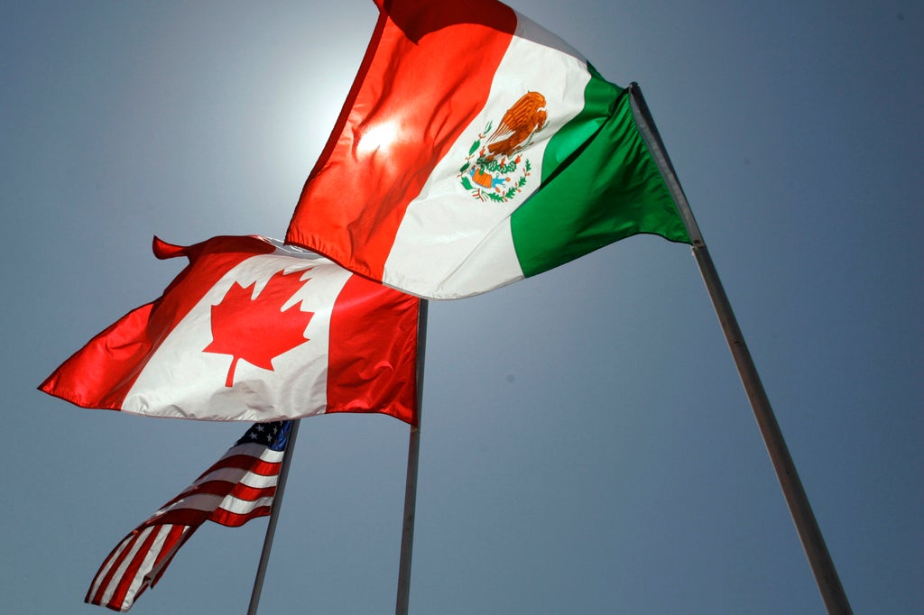 National flags representing the United States, Canada, and Mexico fly in the breeze in New Orleans where leaders of the North American Free Trade Agreement met on April 21, 2008