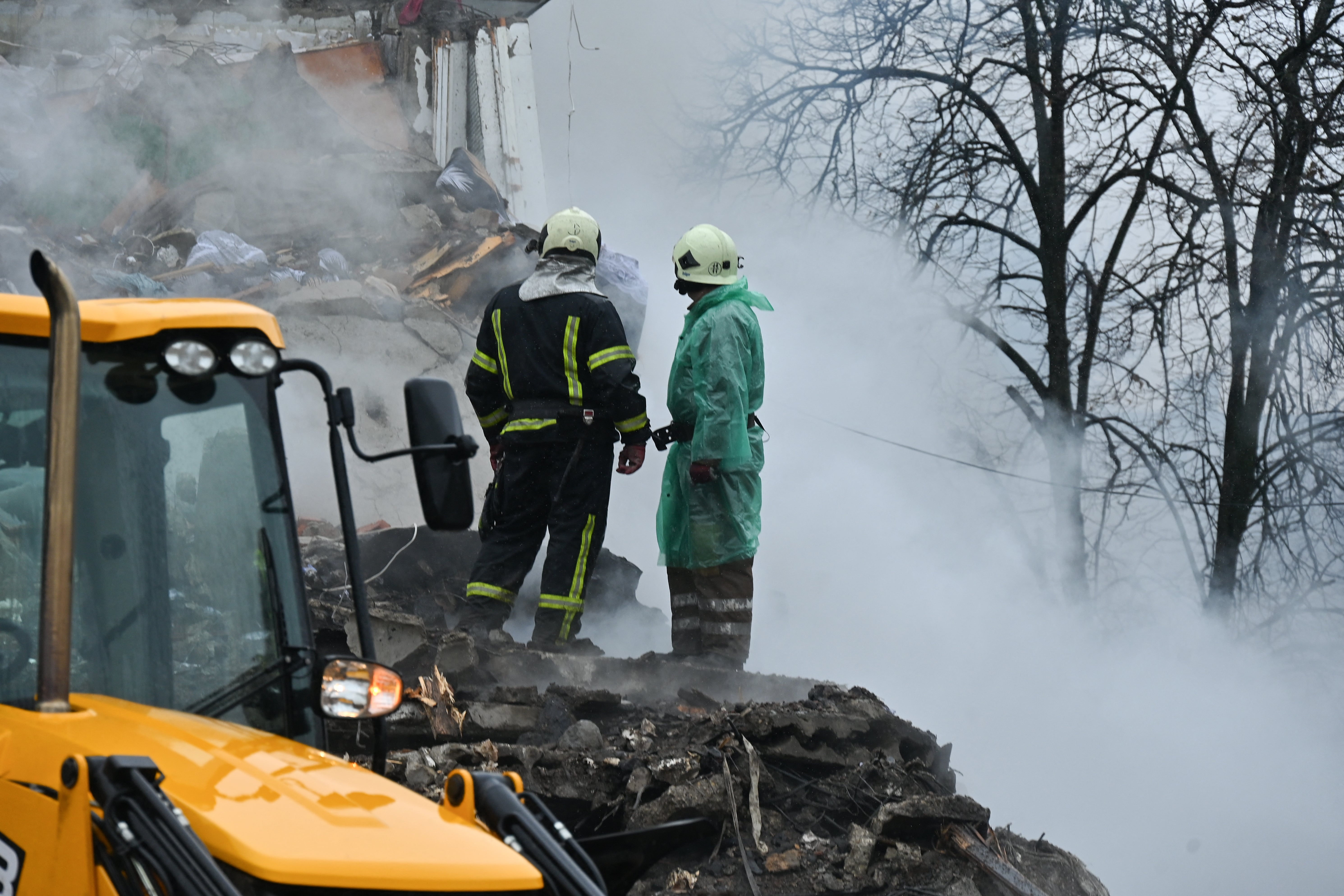 Firefighters look at the rubble of a damaged residential building following a missile strike in Poltava on 1 February 2025