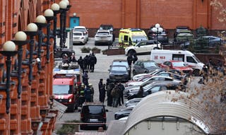 Law enforcement officers work at the site of a blast in a residential building in Moscow,