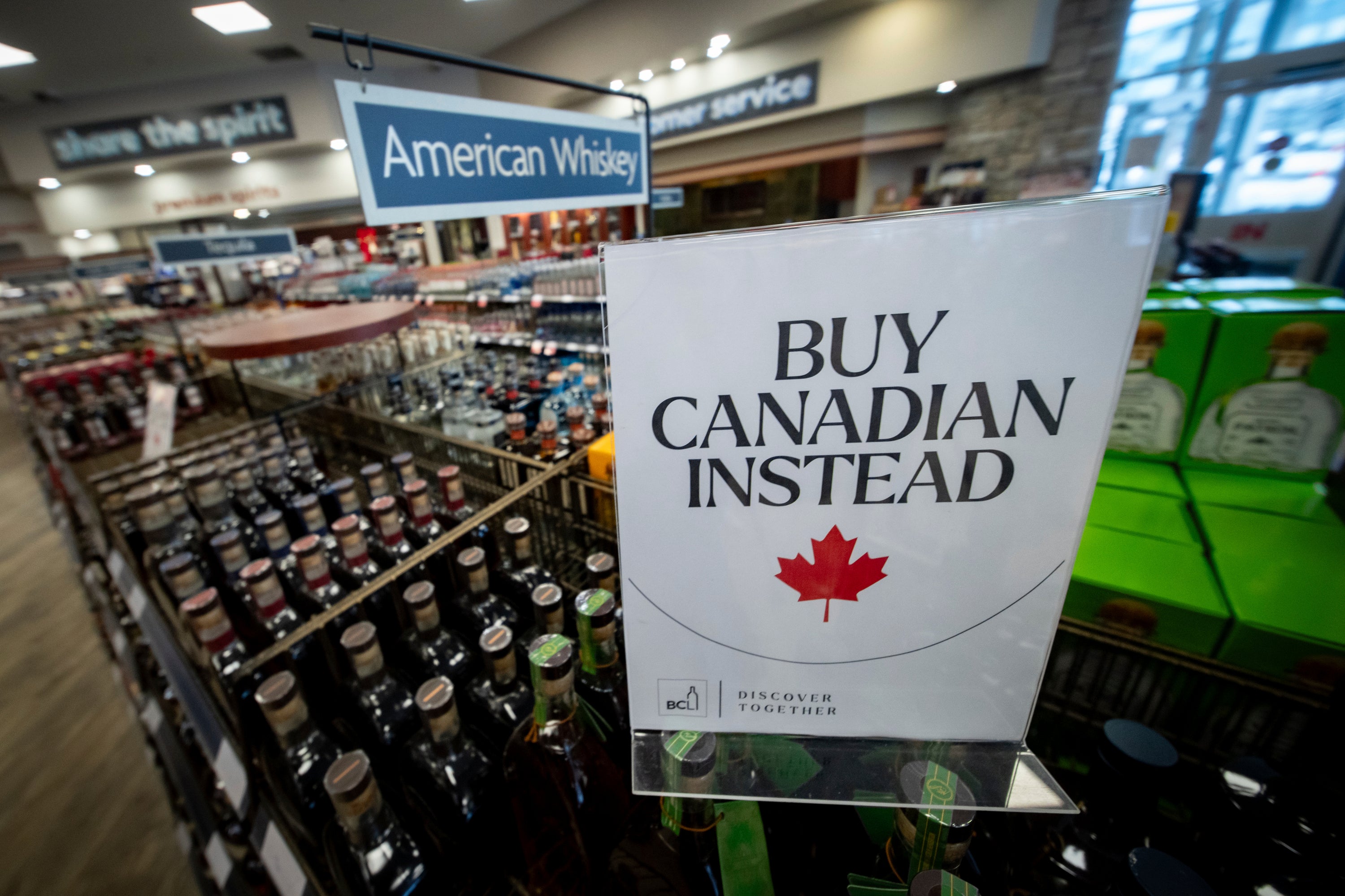 A sign is placed in front of the American whiskey section at a B.C. liquor store after top selling American made products have been removed from shelves in Vancouver, B.C., Sunday, Feb. 2, 2025