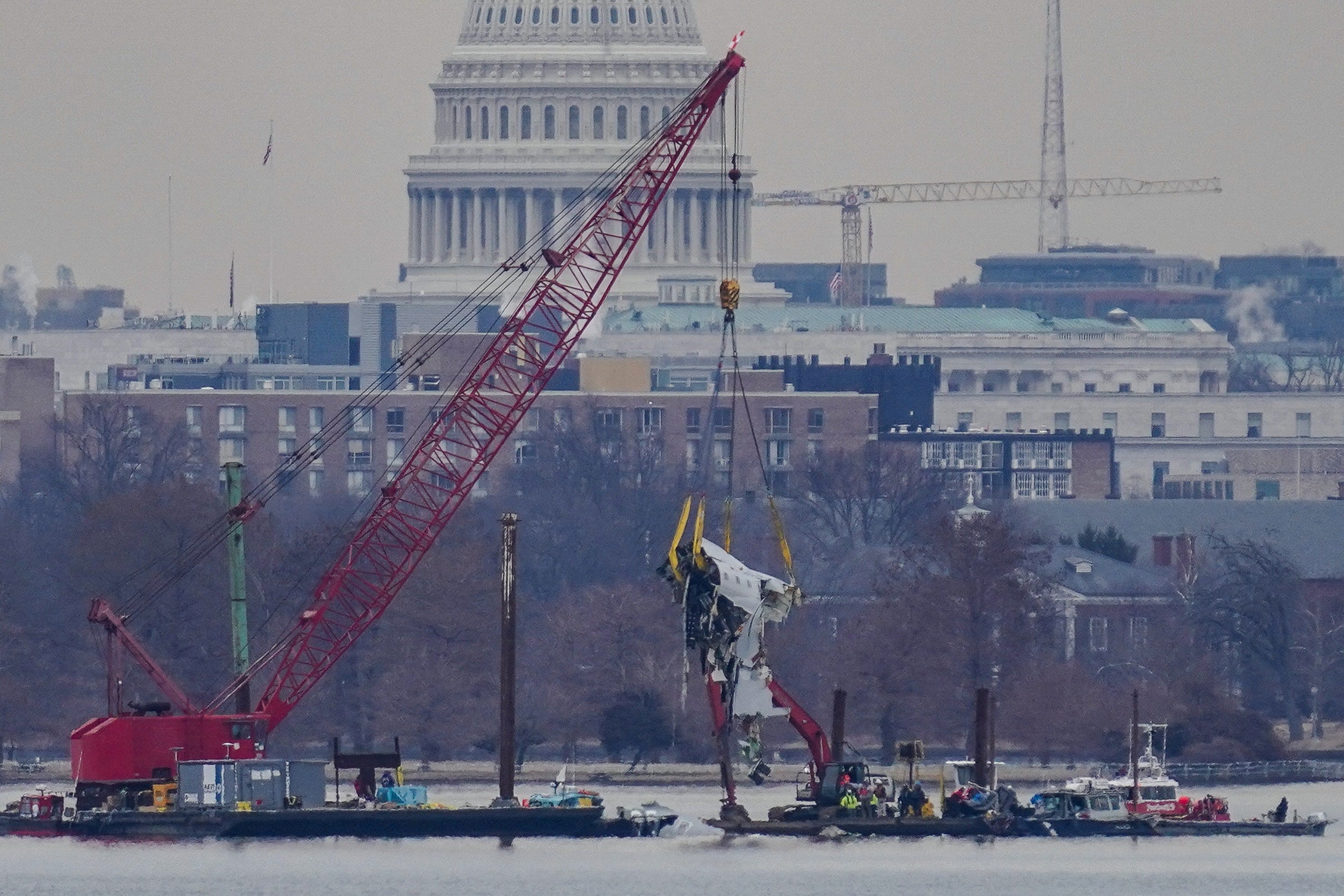 Wreckage from the fatal crash in Washington, D.C., last month is lifted from the Potomac River. Former FAA staffers say Trump’s recent job cuts to the agency will only create more risks