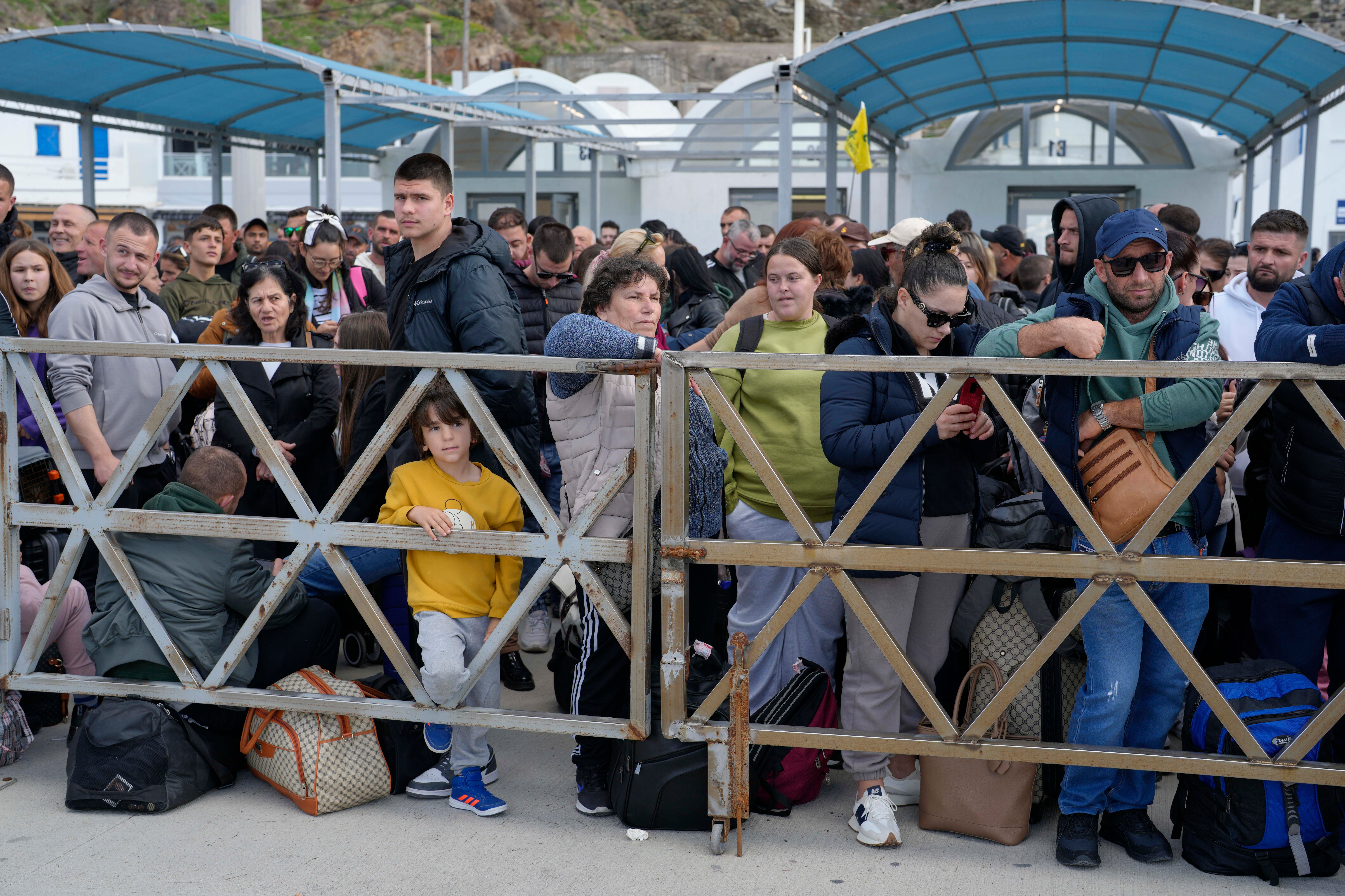 People wait for the arrival of a regularly scheduled ferry to Athens' port of Piraeus, after a spike in seismic activity raised concerns about a potentially powerful earthquake in Santorini, southern Greece, Monday, Feb. 3, 2025