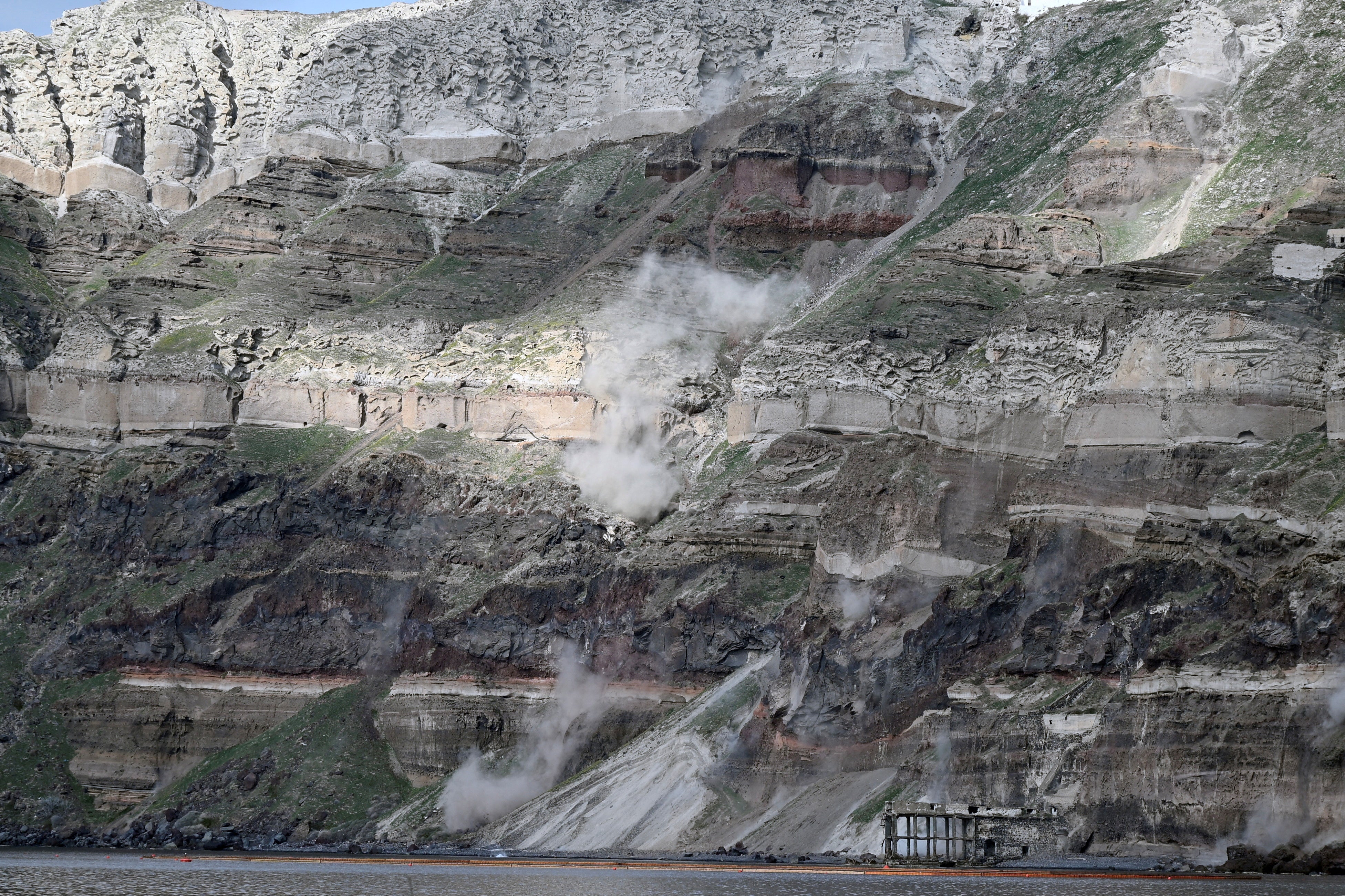 Dust rises following a landslide during high seismic activity, on the island of Santorini, Greece, February 3,