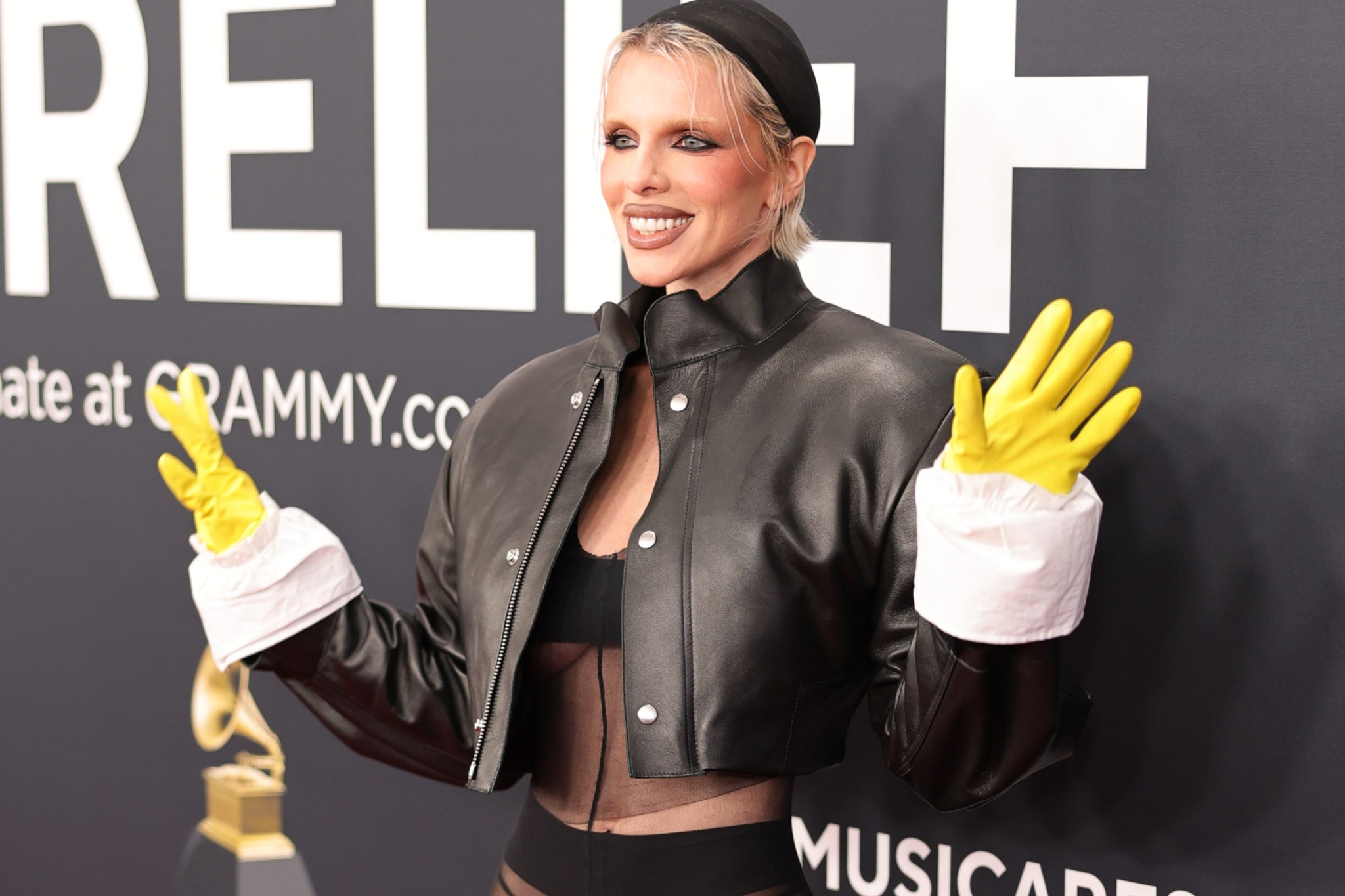 Julia Fox stuns Grammys red carpet with yellow kitchen gloves and sheer outfit | The Independent