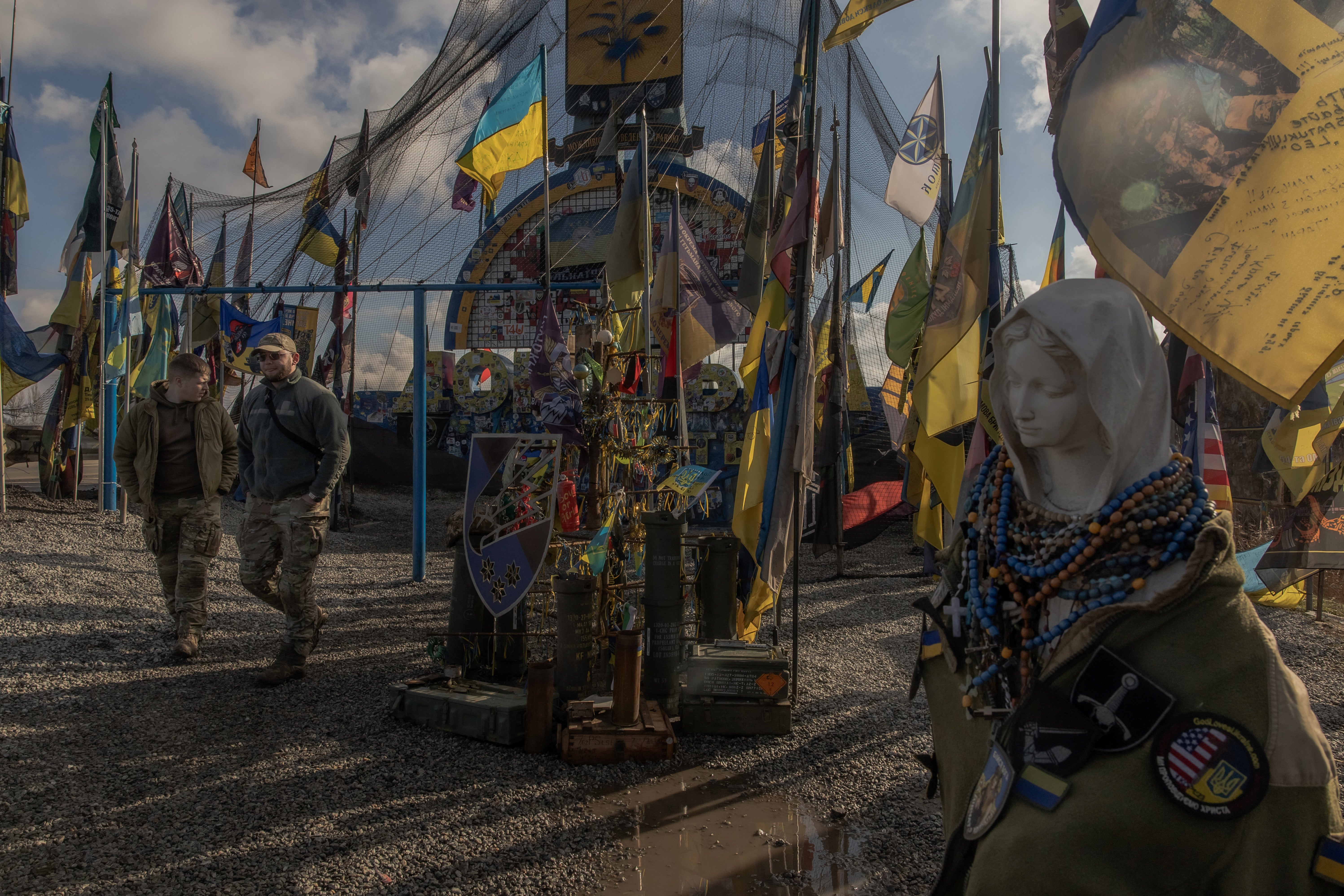 Ukraine Army members visit the entrance mark of the Donetsk area protected by Net anti -drone aircraft and surrounded by Ukrainian brigade flags