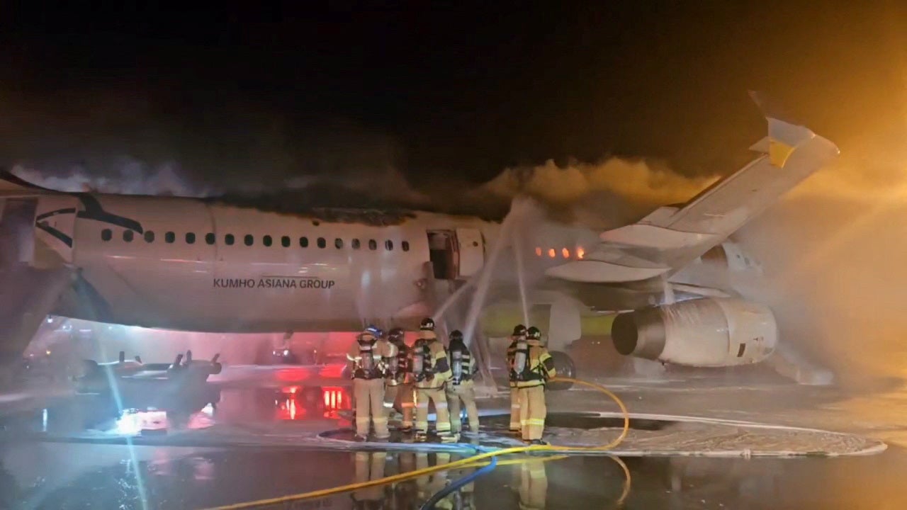 Firefighters try to put out the fire from an Air Busan plane at Gimhae International Airport in Busan, South Korea, January 28, 2025