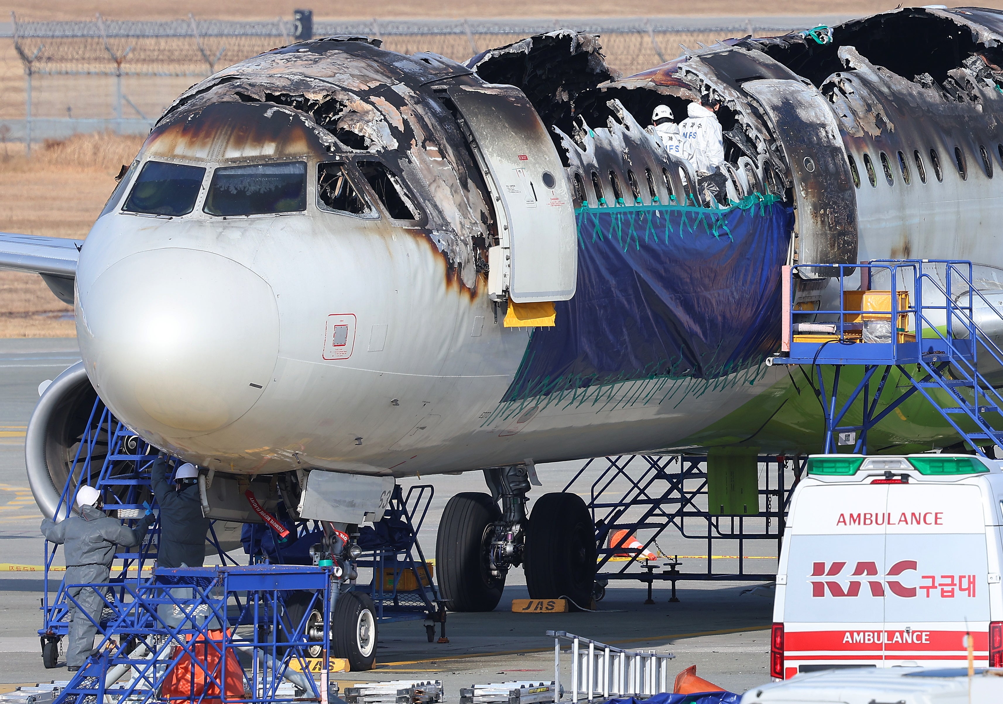<p> Inspectors examine the burnt Air Busan plane after it caught fire at the airport before takeoff on 31 January 2025 at Gimhae International Airport in the southeastern port city of Busan, South Korea, 03 February 2025</p>