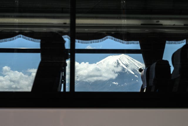 <p>File. Mount Fuji is seen through a bus window</p>