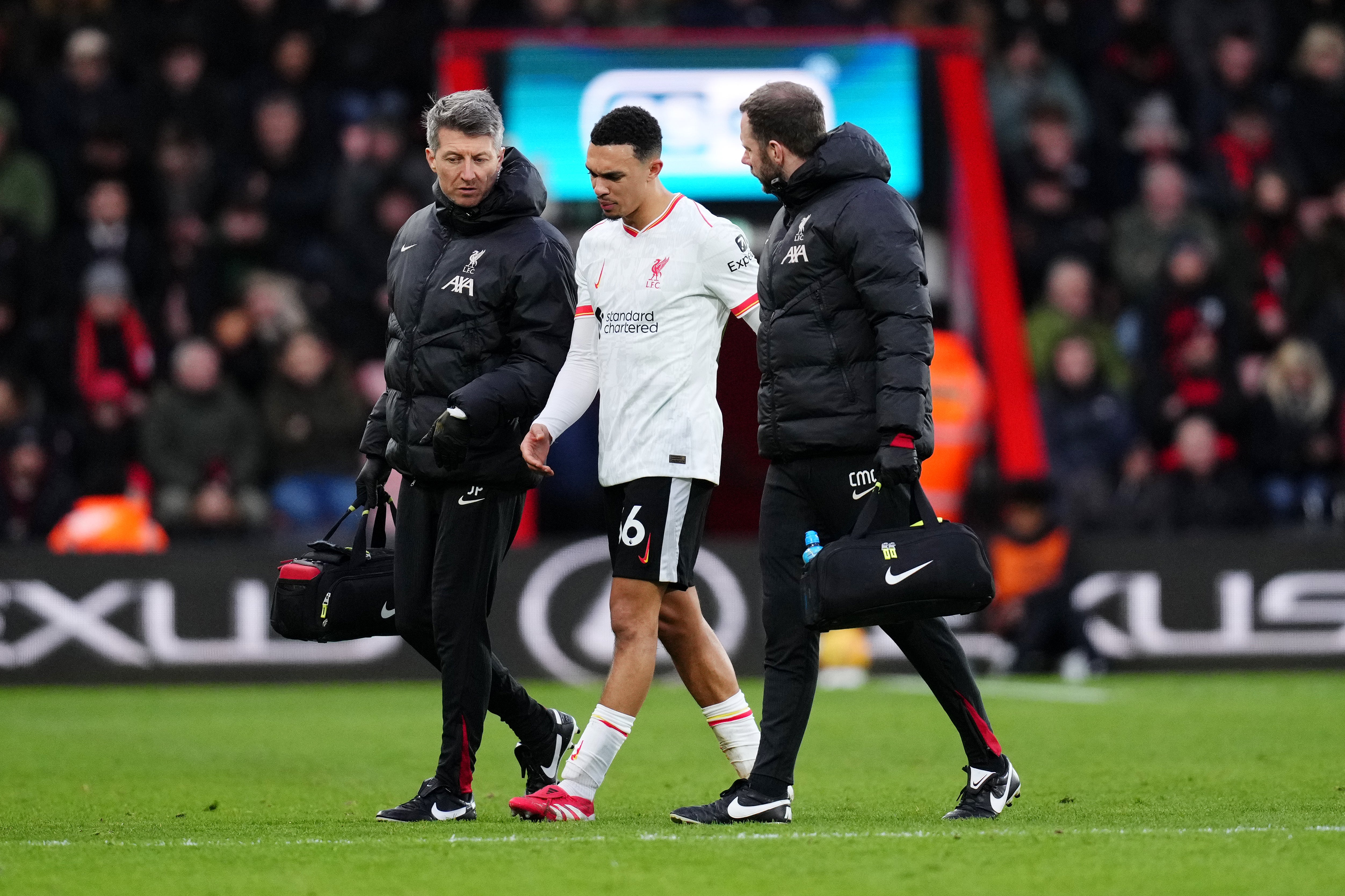 Liverpool's Trent Alexander-Arnold leaves the pitch with medical staff after going down injured at the Vitality Stadium