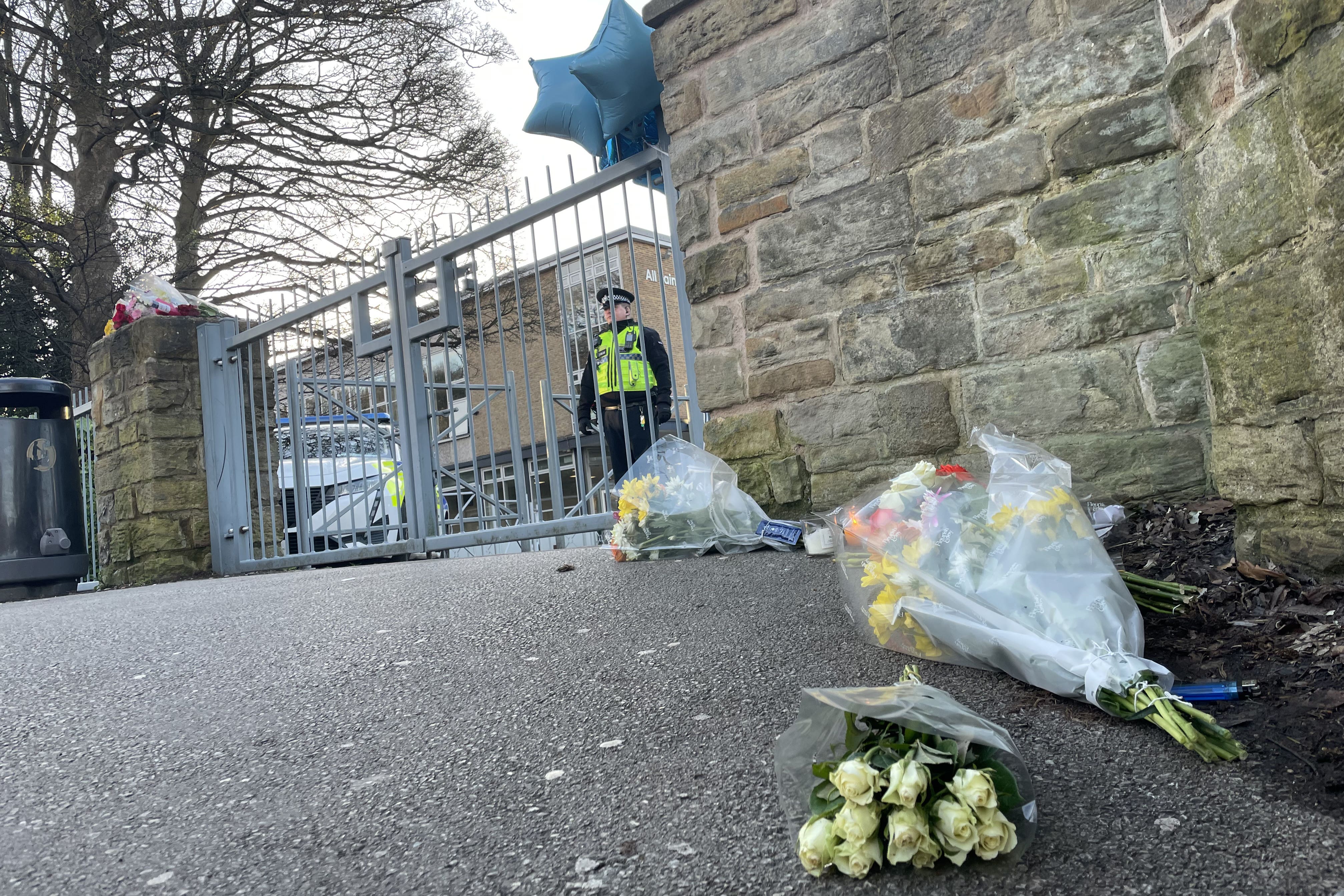 Floral tributes were left outside All Saints Catholic High School in Sheffield (Sophie Robinson/PA)